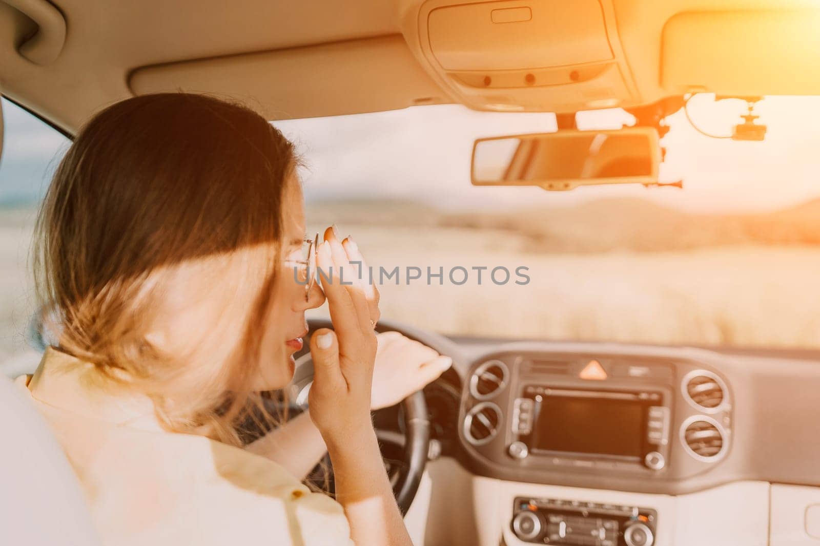 Relaxed business woman talking on video call on phone in automobile. Rested female professional saying bye on video chat in business car. Beautiful lady making video message in luxury car.