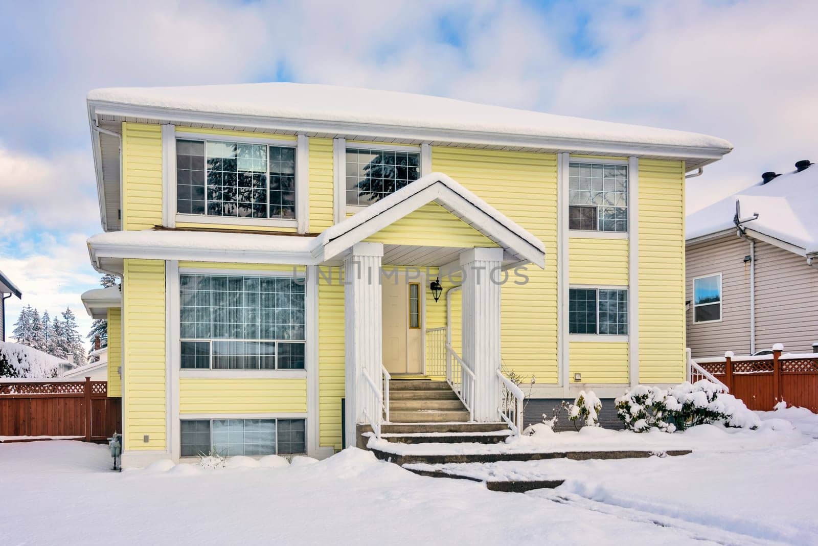 Yellow residential house on winter season in Vancouver, Canada.