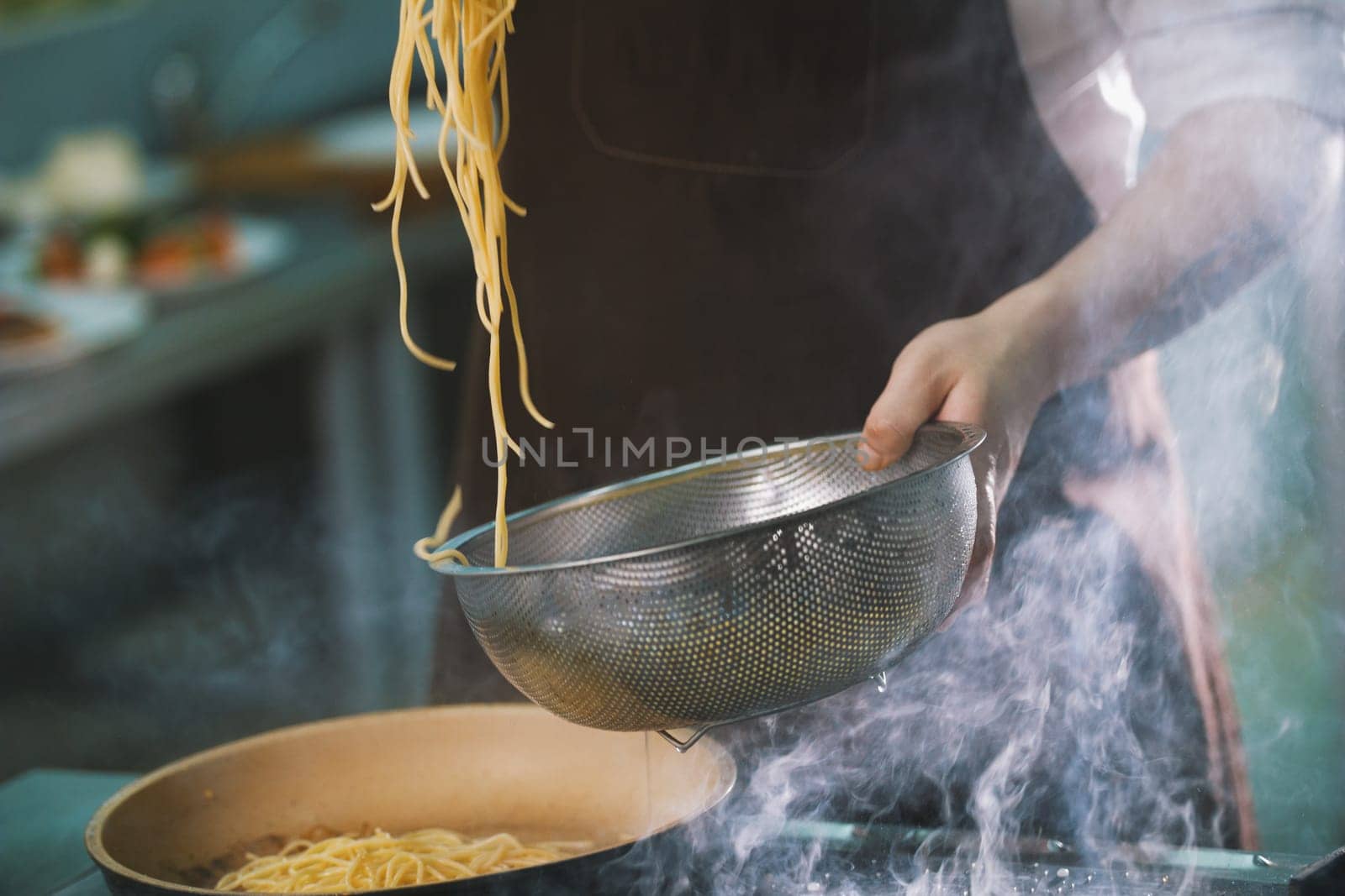 Process of cooking spaghetti in restaurant close-up