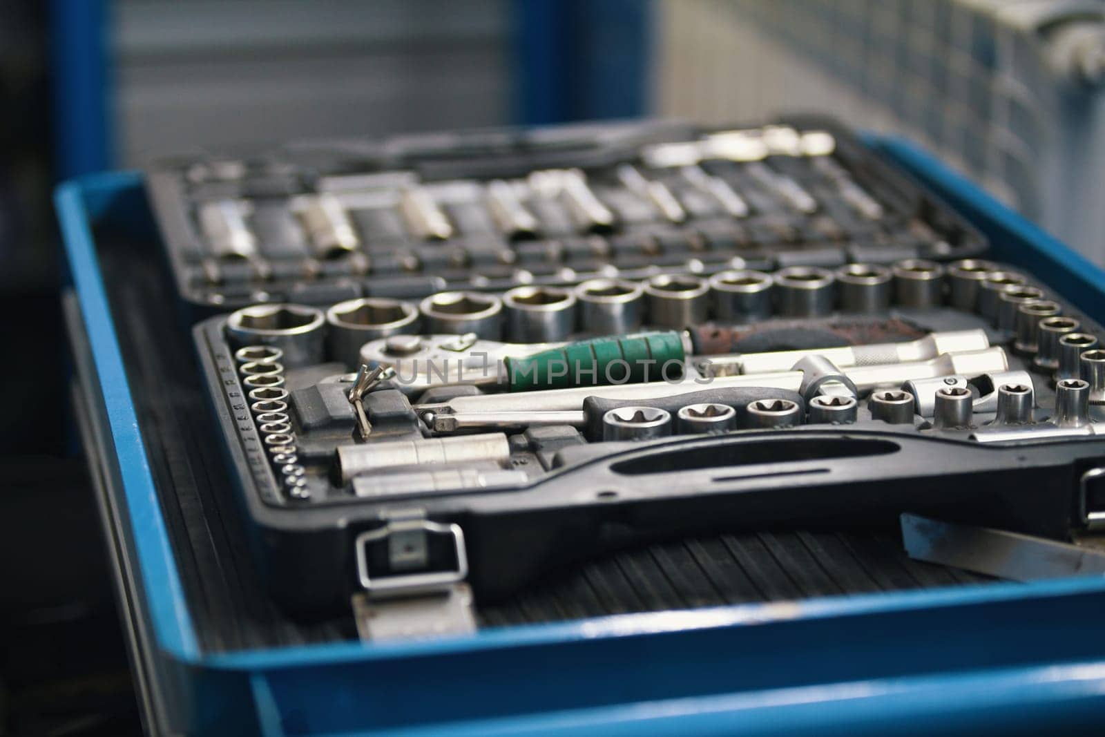 A set of tools for repair - screwdriver, voltmeter, wrenches - car service, close up view