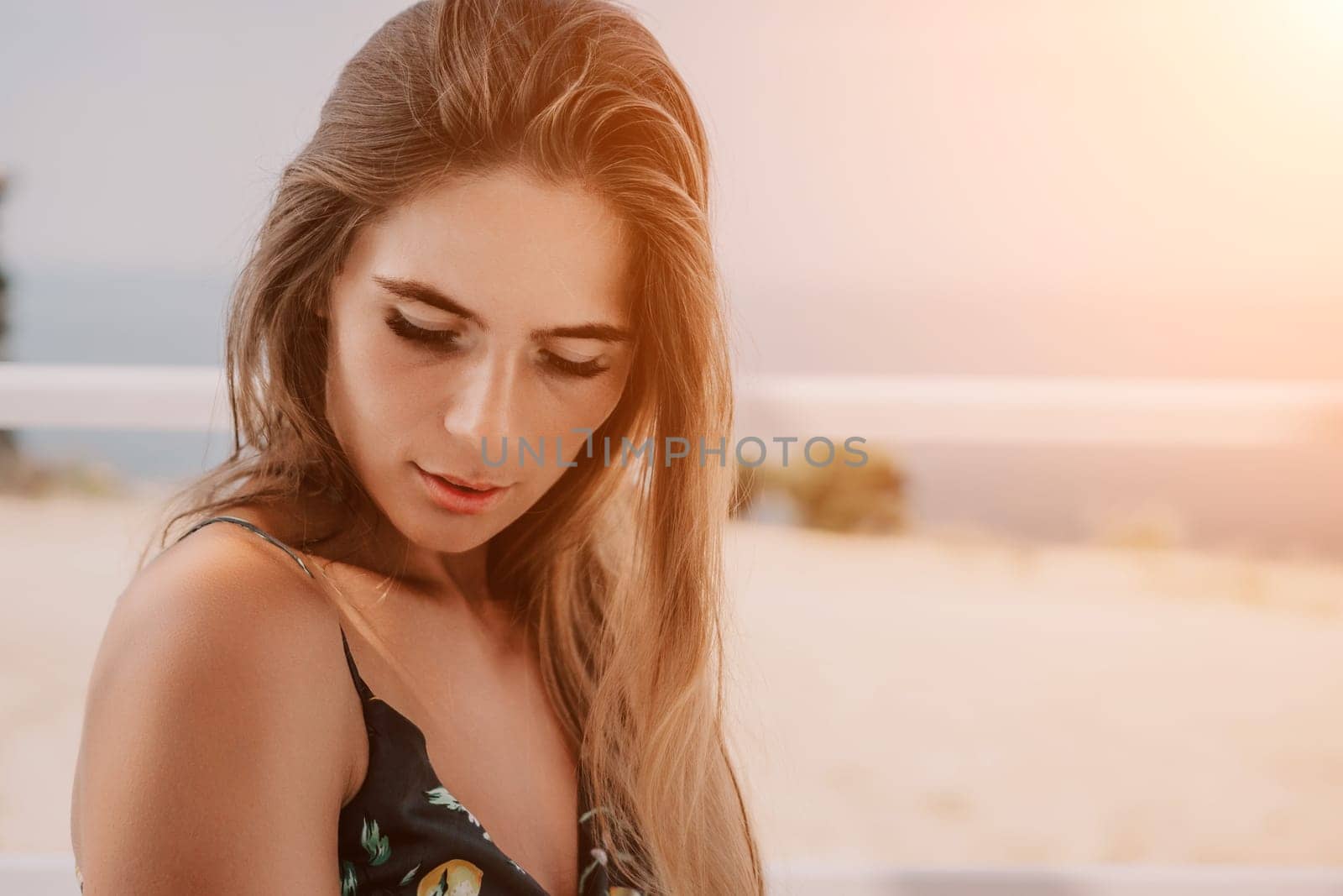 Happy woman portrait in cafe. Boho chic fashion style. Outdoor photo of young happy woman with long hair, sunny weather outdoors sitting in modern cafe