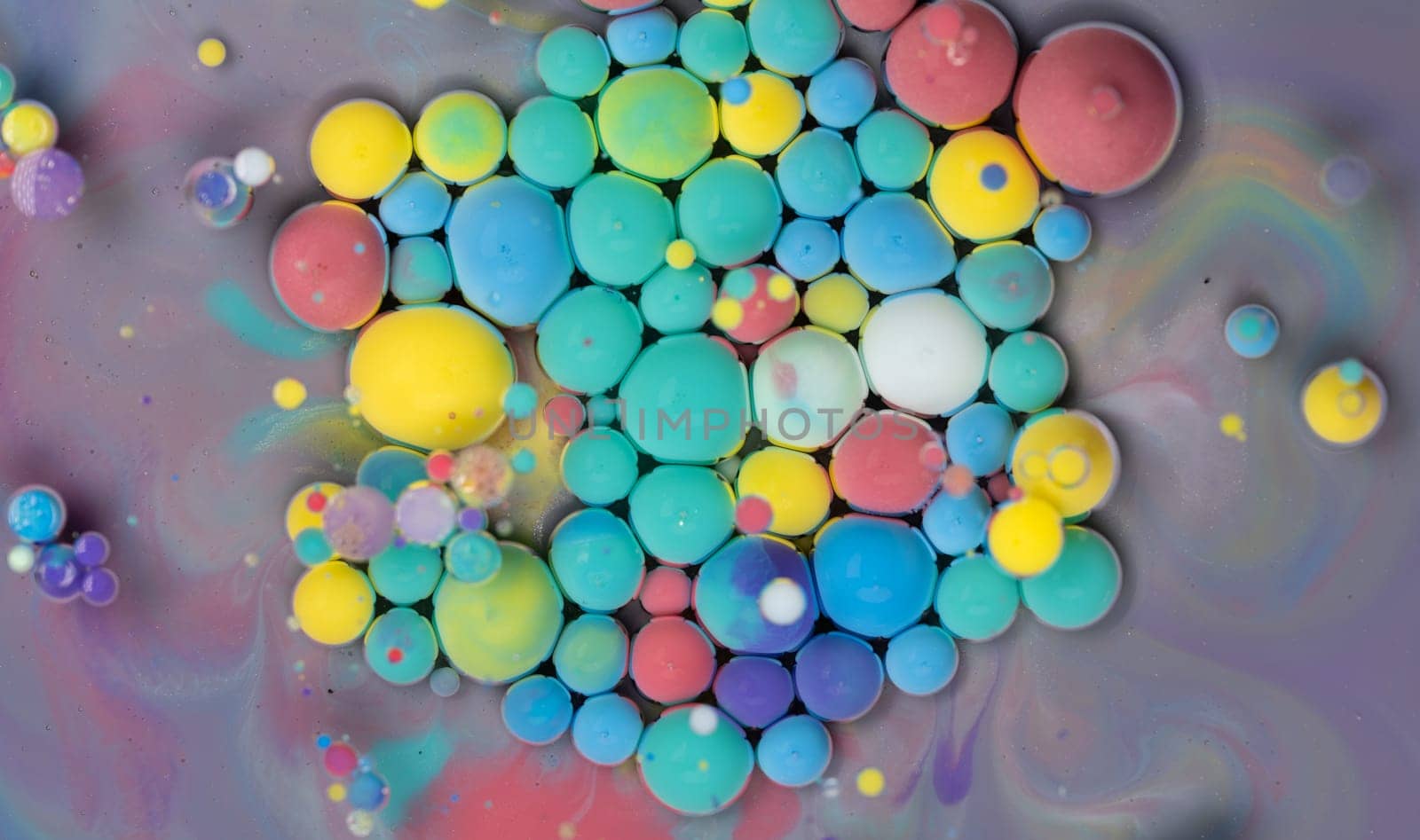 A Symphony of Spheres in Lavender HA close-up shot of vibrant, colorful spheres suspended in a lavender liquid, creating a mesmerizing abstract pattern.ues. High quality photo