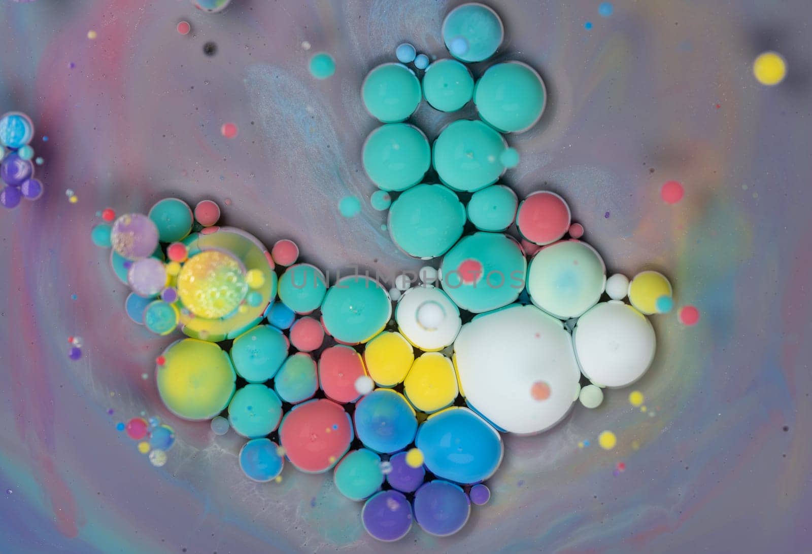 This artwork features a captivating arrangement of colorful bubbles in different sizes, blending various shades under soft light, creating an enchanting, abstract display.