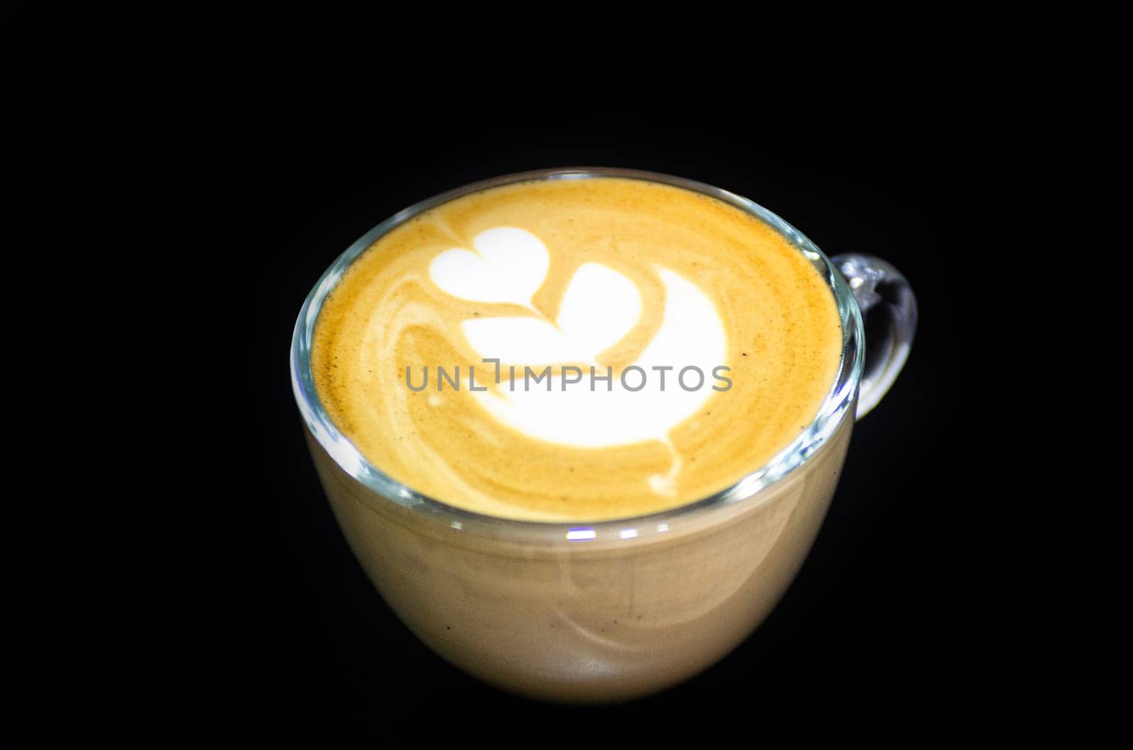 Hot latte art on black table close up macro