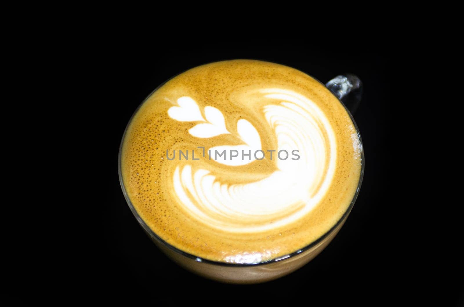 Hot latte art on black table close up macro