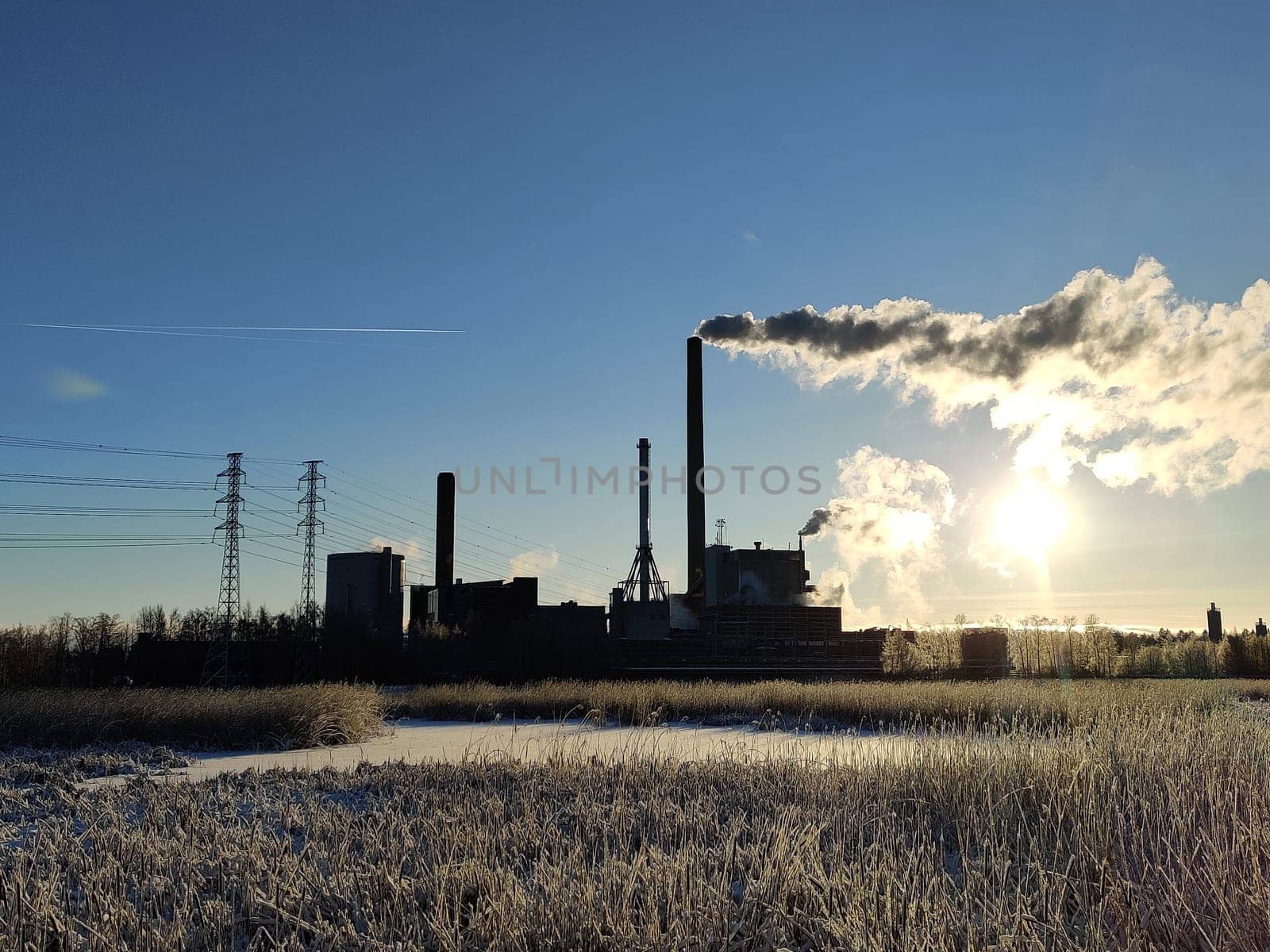 Espoo, Finland, January 01, 2024 - Gas and coal Suomenojan power plant in winter morning, Finland. With copy space