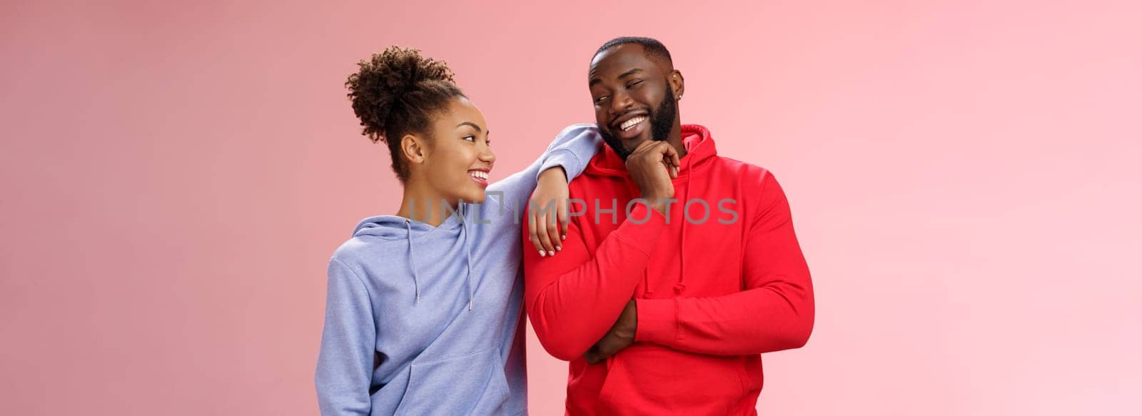 Two best friends having fun man smiling woman leaning his shoulder talking laughing joking like spending time together, standing pink background chit-chat confident relaxed poses. Copy space