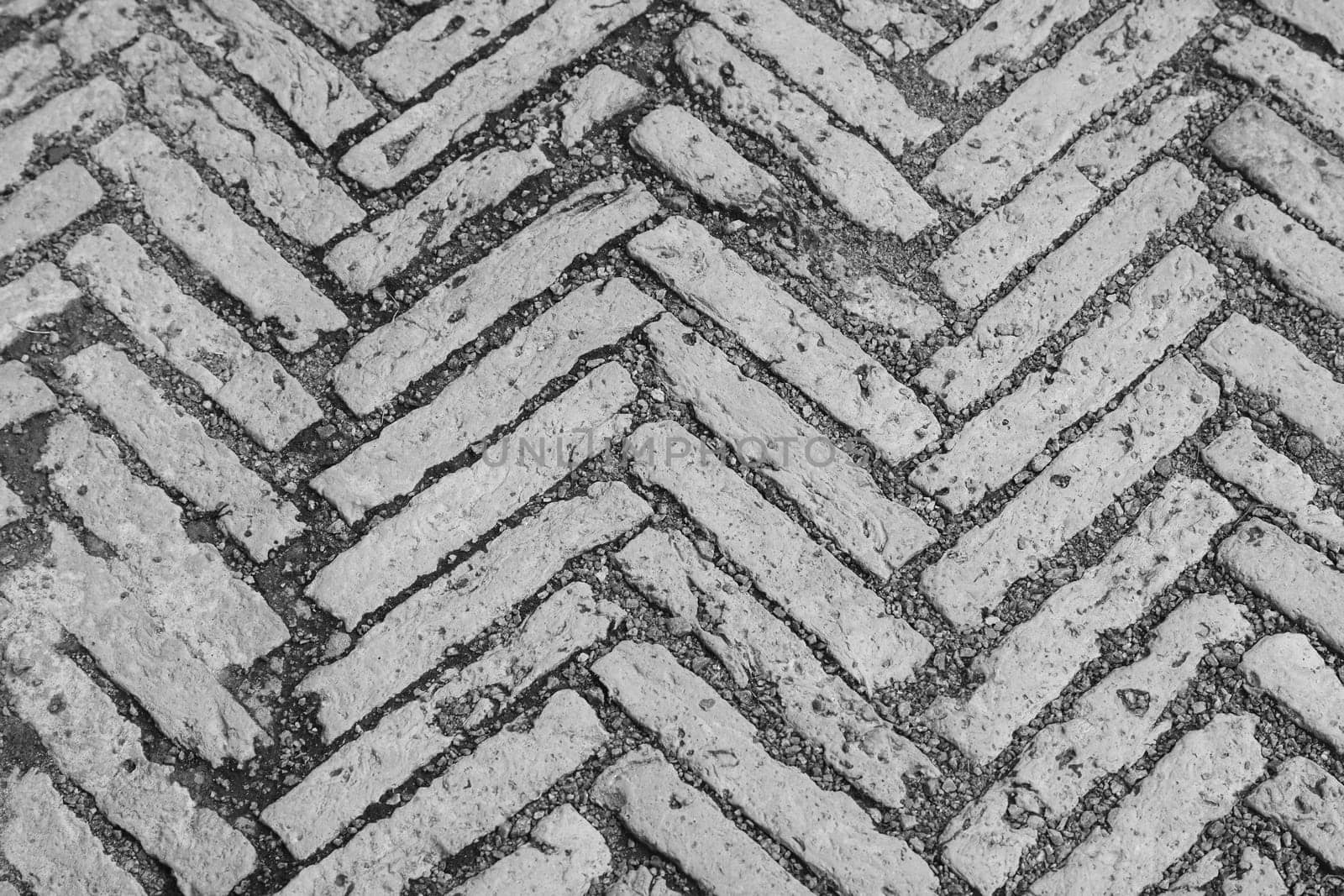 The road surface is made of bricks.