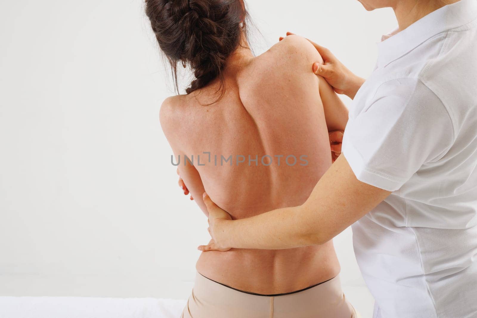 a therapist rehabilitation specialist checks the mobility of the spinal arches. Evaluation of the preservation of mobility in the lumbar and thoracic region