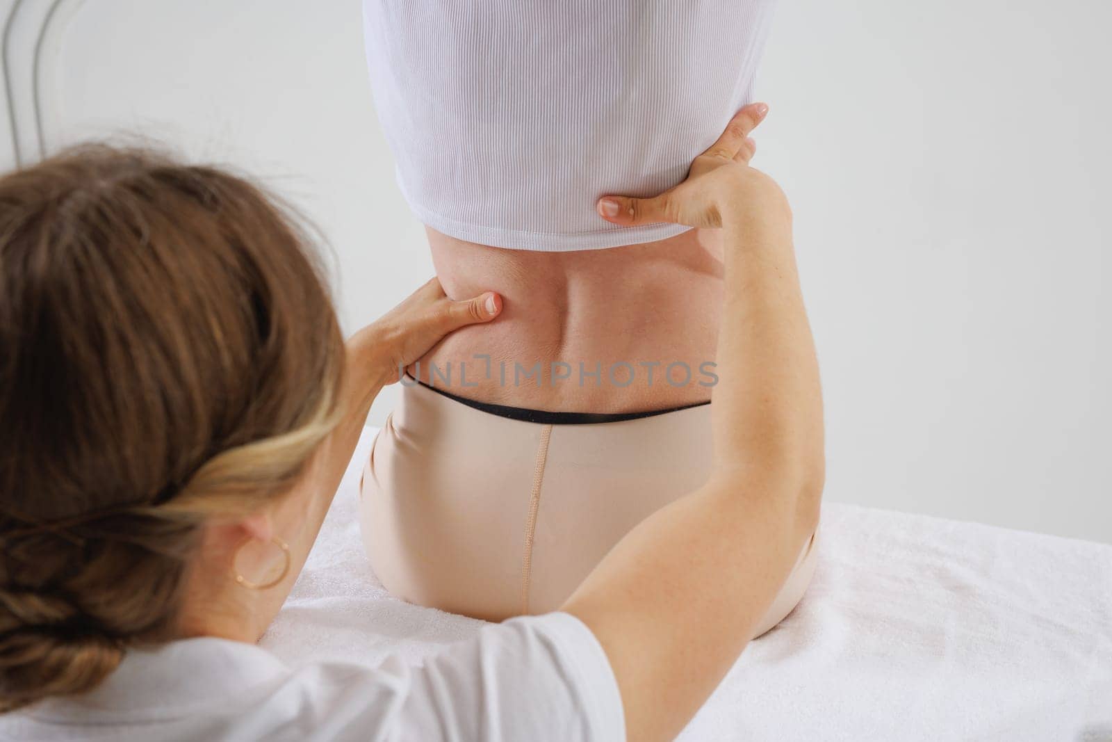 a therapist rehabilitation specialist checks the mobility of the spinal arches. Evaluation of the preservation of mobility in the lumbar and thoracic region