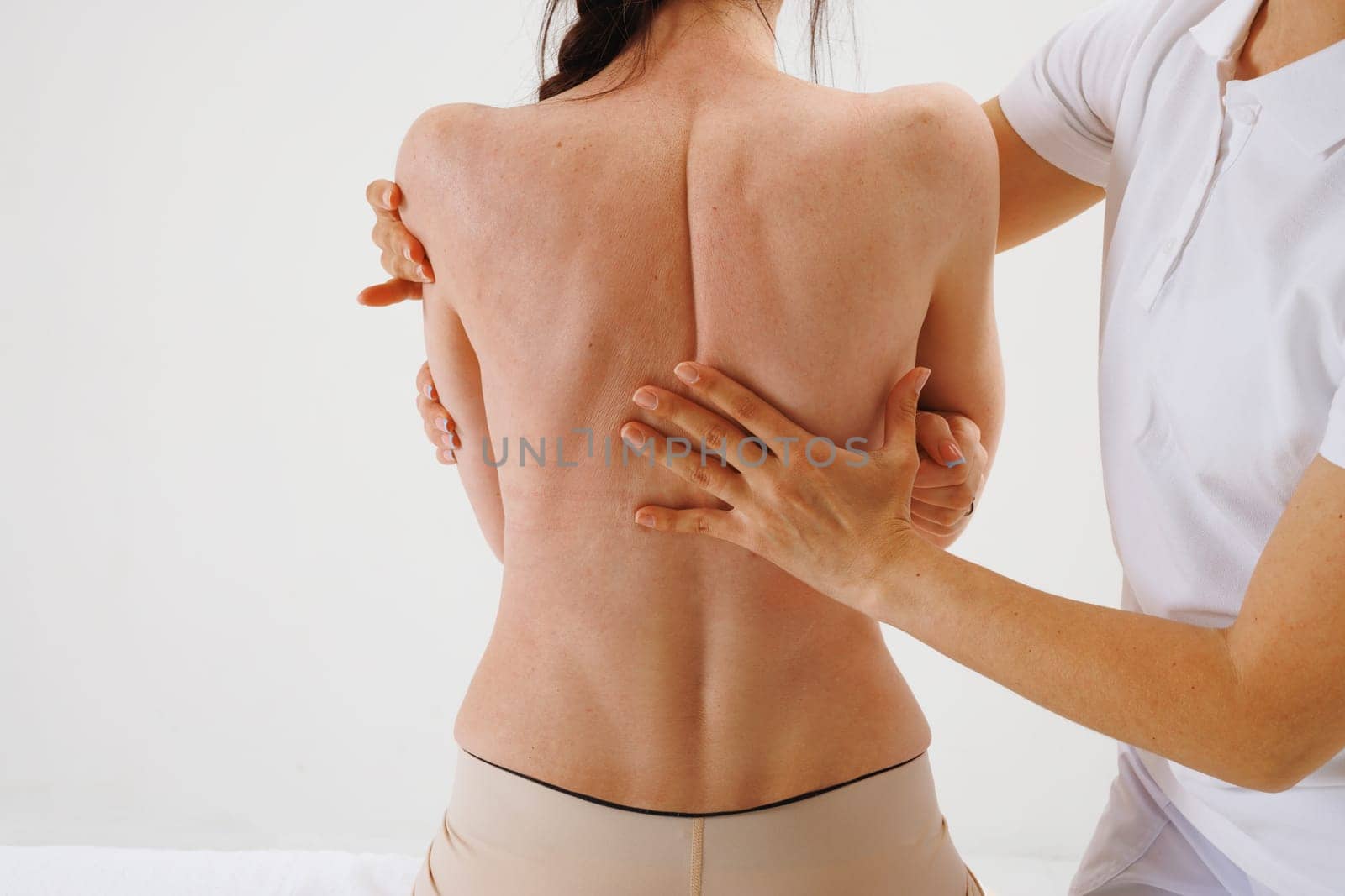 a therapist rehabilitation specialist checks the mobility of the spinal arches. Evaluation of the preservation of mobility in the lumbar and thoracic region