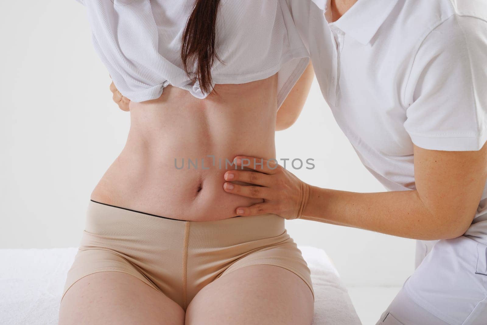 a therapist rehabilitation specialist checks the mobility of the spinal arches. Evaluation of the preservation of mobility in the lumbar and thoracic region