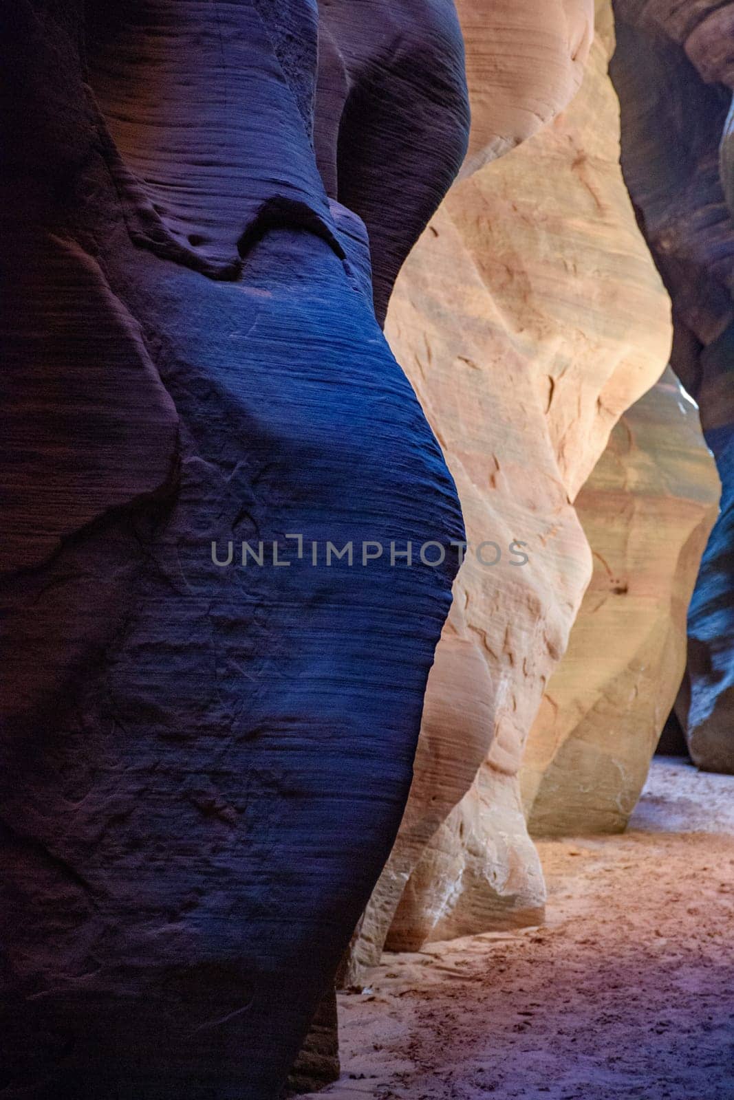 The vivid contrast of colors within the narrow walls of Buckskin Gulch Slot Canyon on the Arizona, Utah border. The light hitting the rock completely changes the color of this natural rock formation.