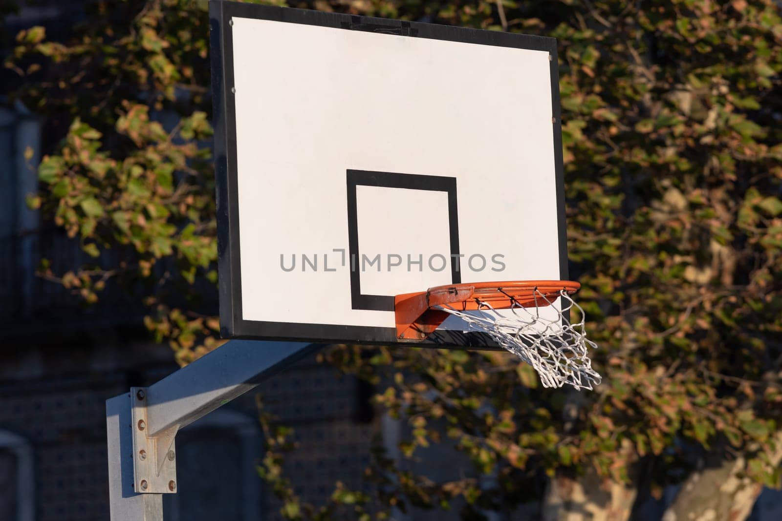 Basketball hoop on outdoor playground. Mid shot