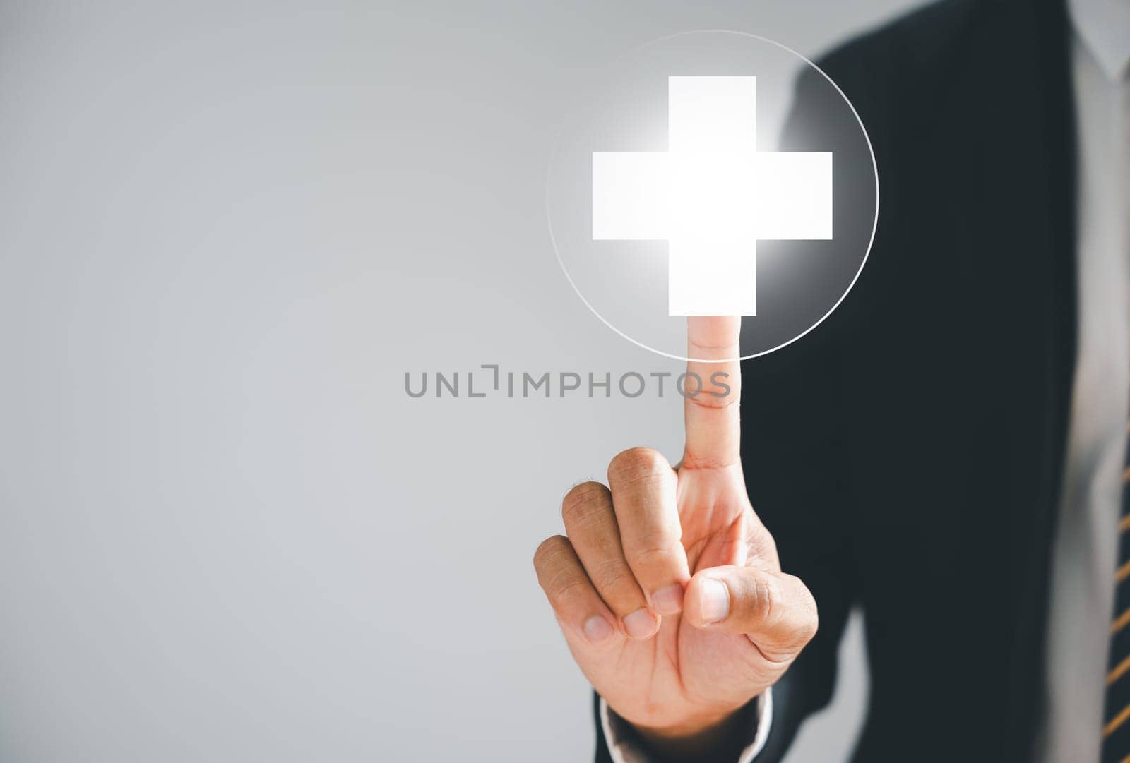 Businessman hand touches a virtual plus sign, symbolizing positivity. Represents more benefits, forward thinking, and a positive mindset. Business and success concept. positive thing
