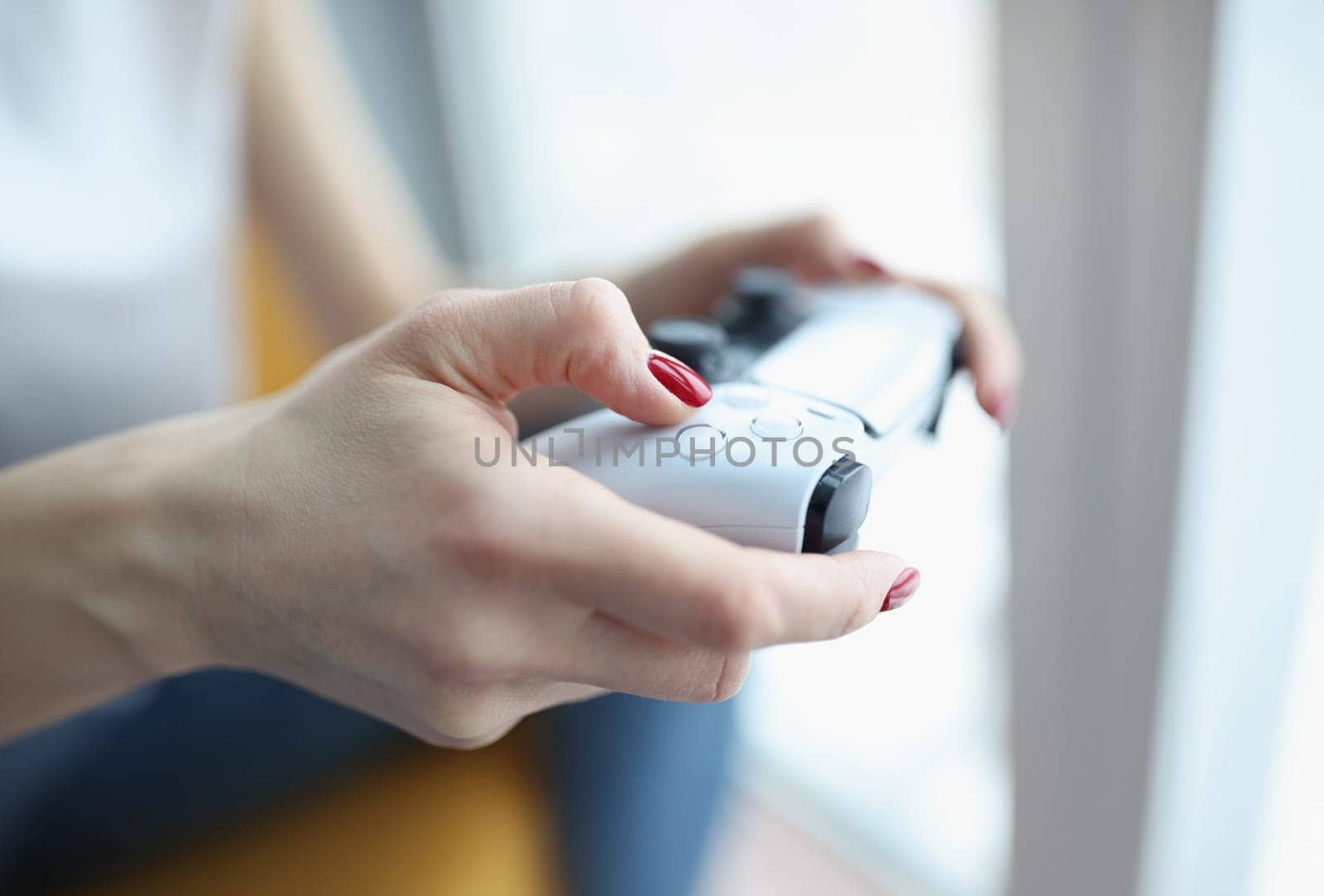 Woman playing computer game with joystick closeup by kuprevich