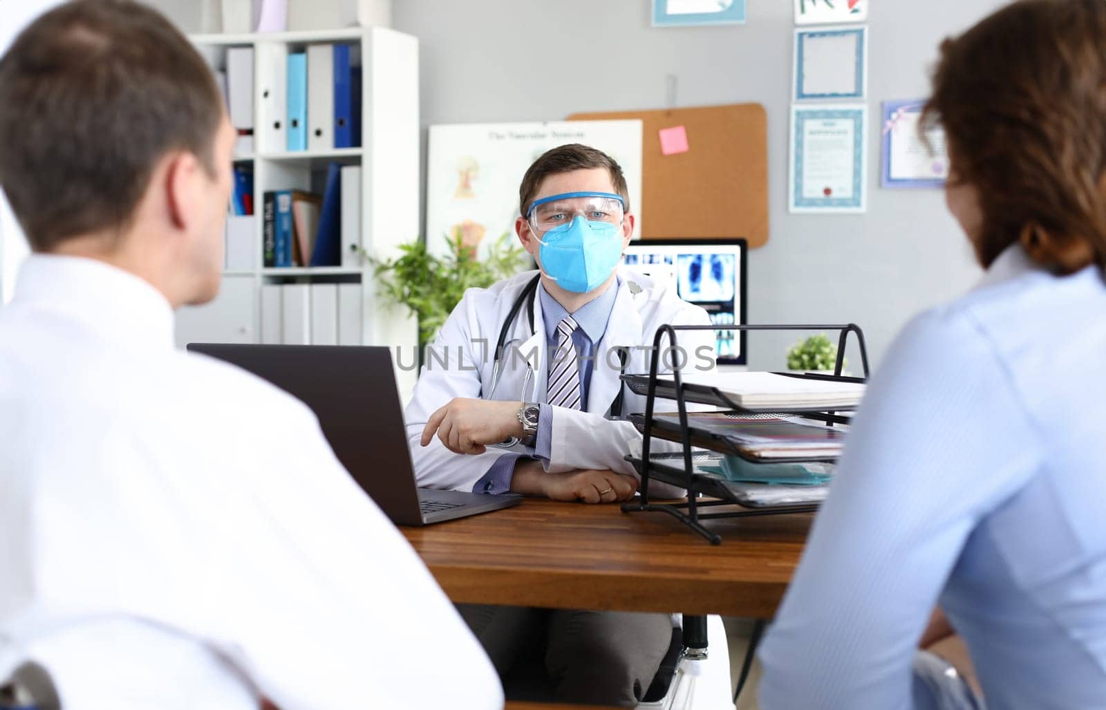Doctor receives patients in protective medical mask. Doctors safety in coronavirus pandemic concept