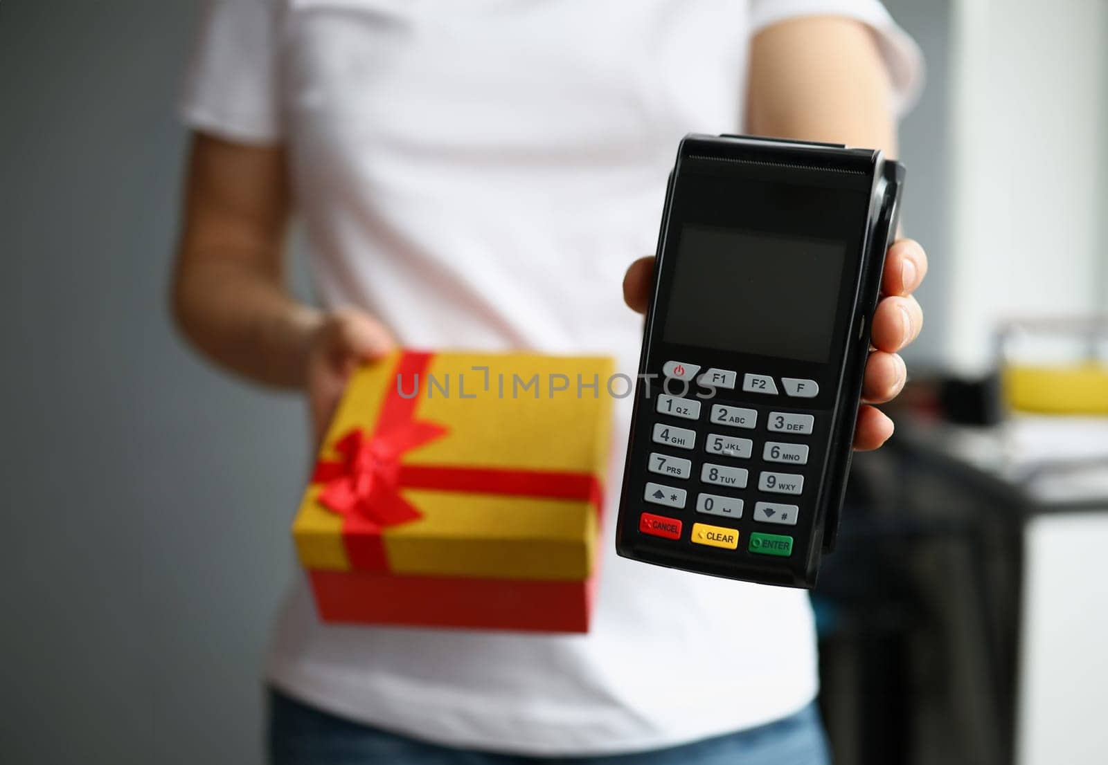 Courier is holding gift box and payment terminal by kuprevich