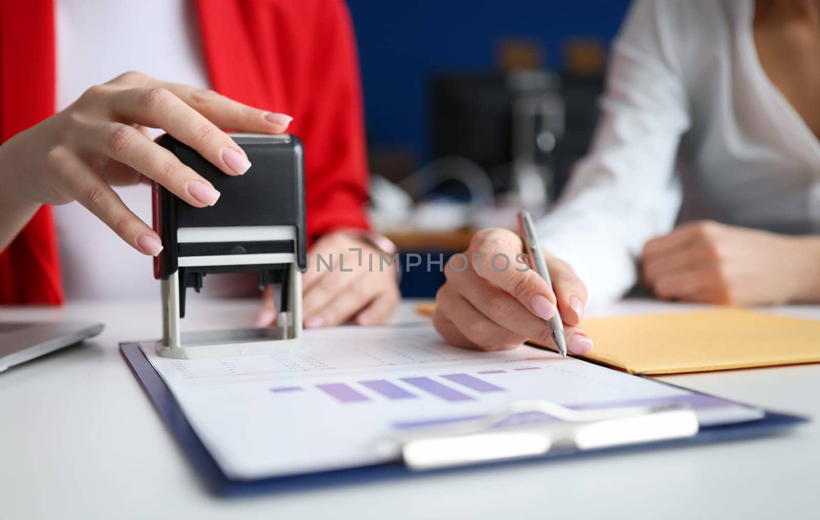 Business women signing document and certifying seal closeup by kuprevich