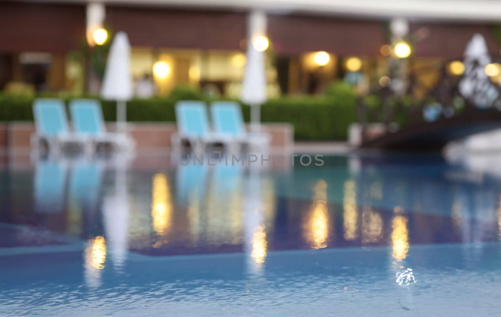 Evening blurred background of resort hotel and pool by kuprevich