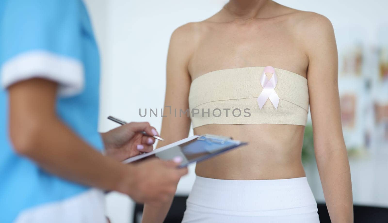Doctor examines patient's mammary glands. Prevention and early detection of breast cancer concept