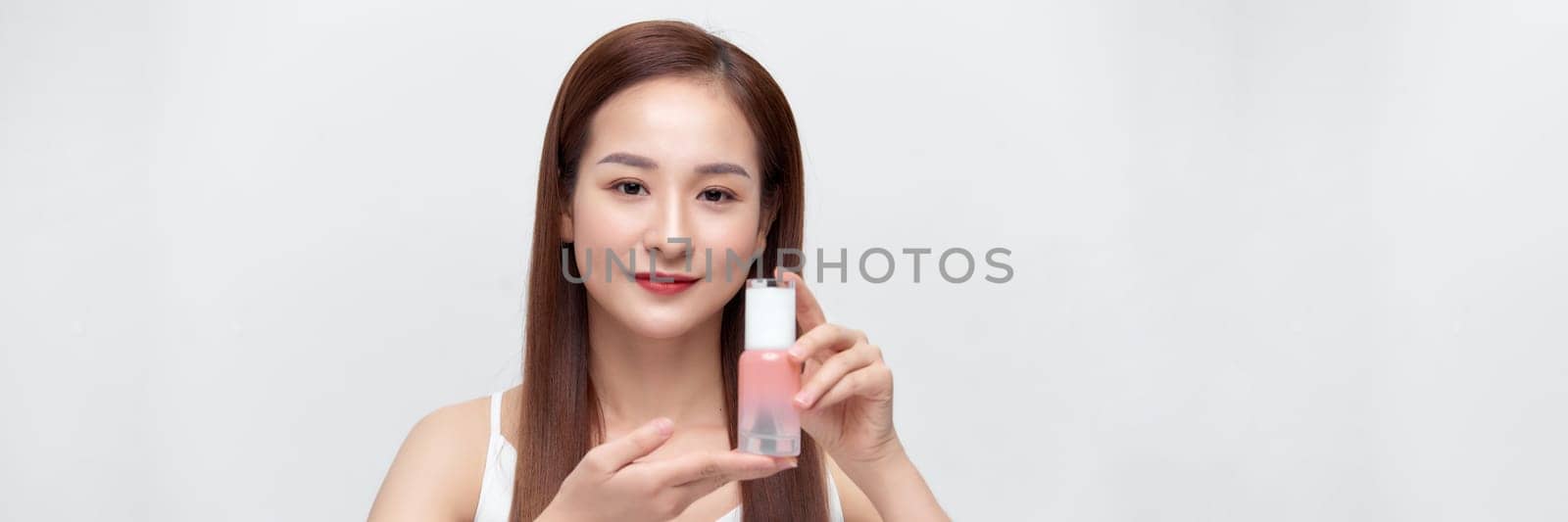 Beauty asian woman model hold cosmetic bottle with smiling on banner by makidotvn