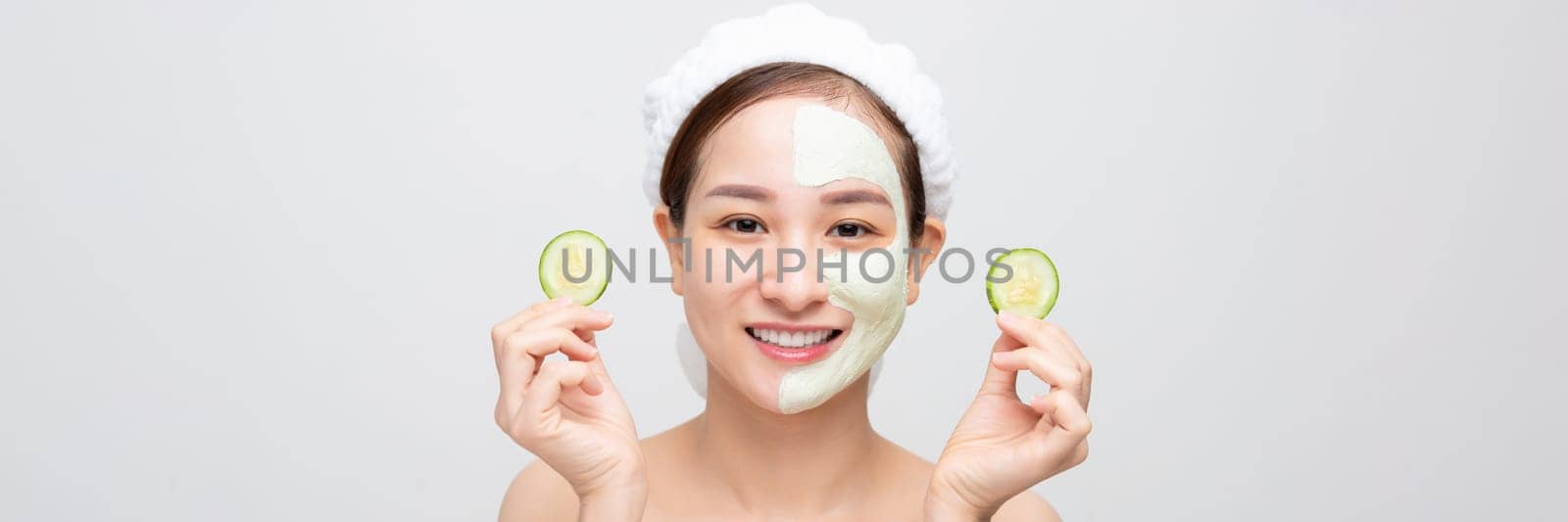 Beautiful young woman with cucumber facial mask on white background. Banner
