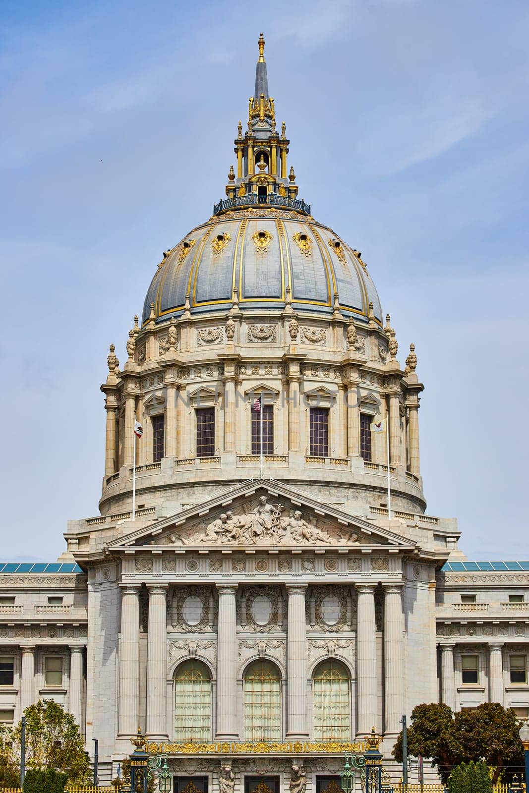 Image of Close up of city hall entrance with focus on gilded dome and white pillars above doors