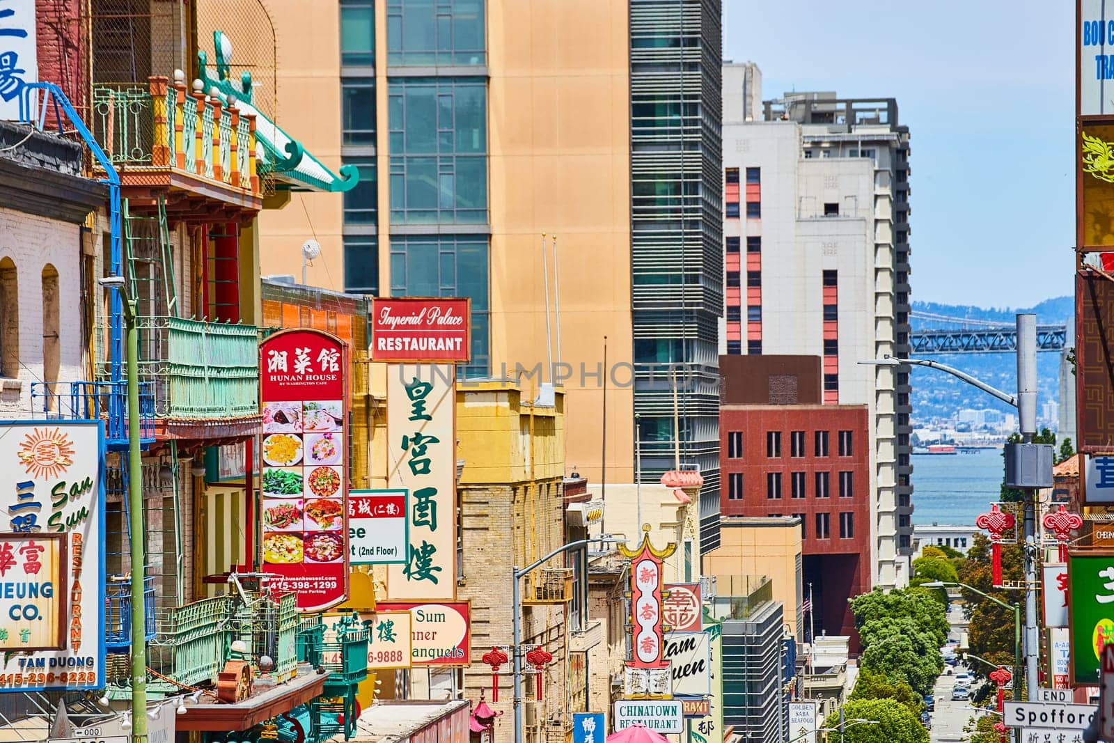 Image of Restaurants and shop signs in Chinese along California street leading to San Francisco Bay