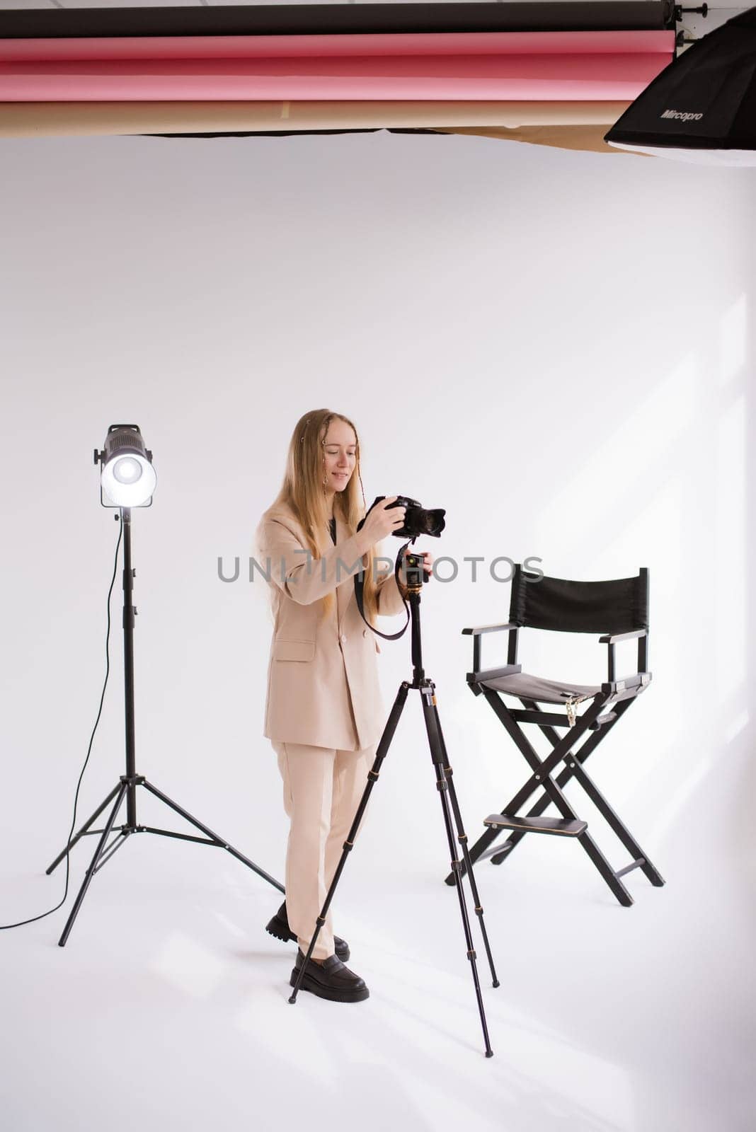 A woman videographer a working at photo studio by OksanaFedorchuk