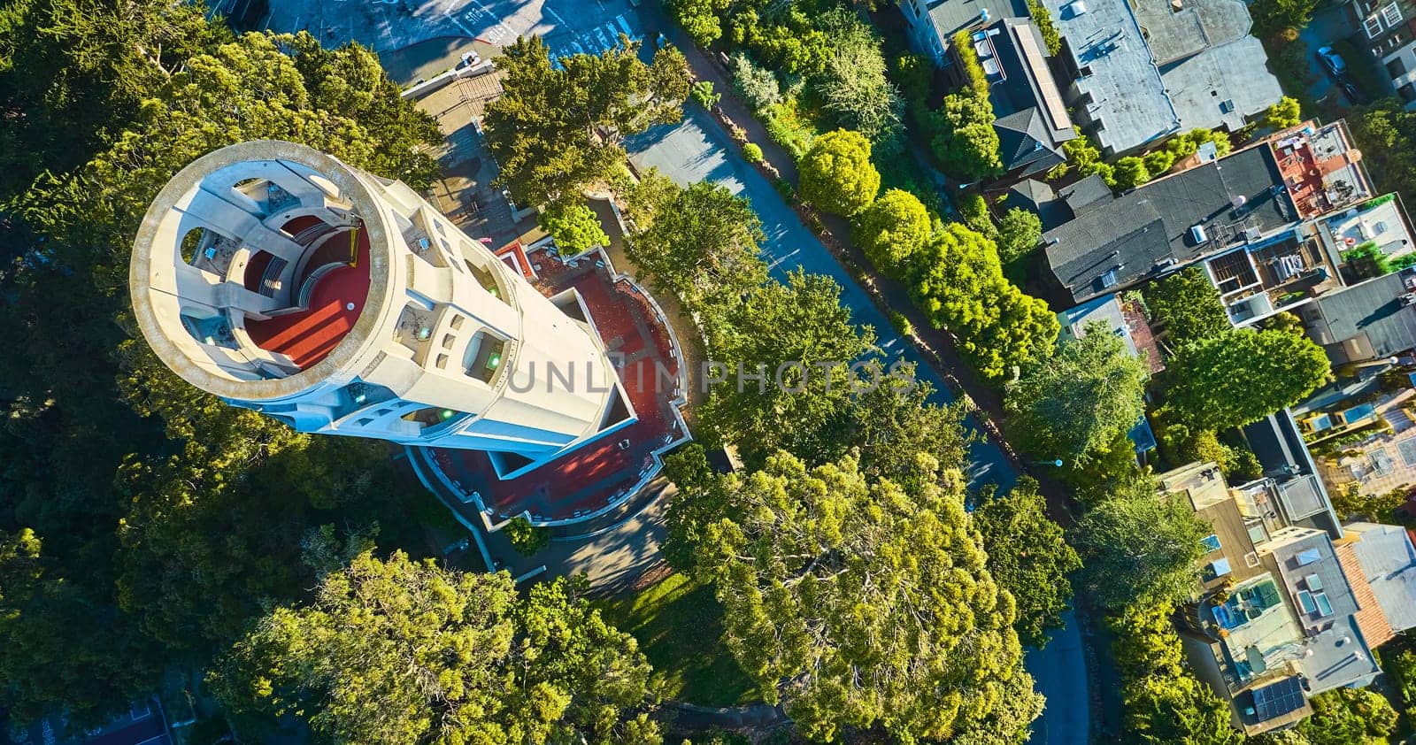 Image of Aerial over Coit Tower with downward view of roof with red floor and stairs