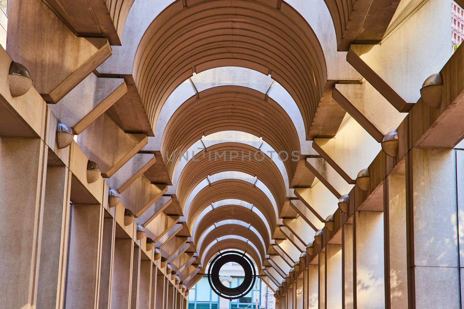 Image of Symmetrical and optical illusion ceiling with curving openings with tunnel view to black opening