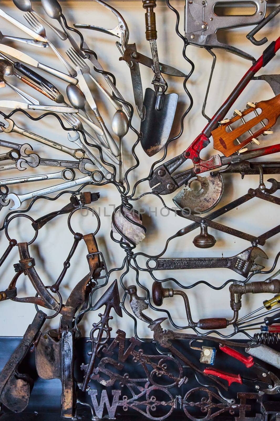 Image of Wall of interconnecting tools connected by wires on white background