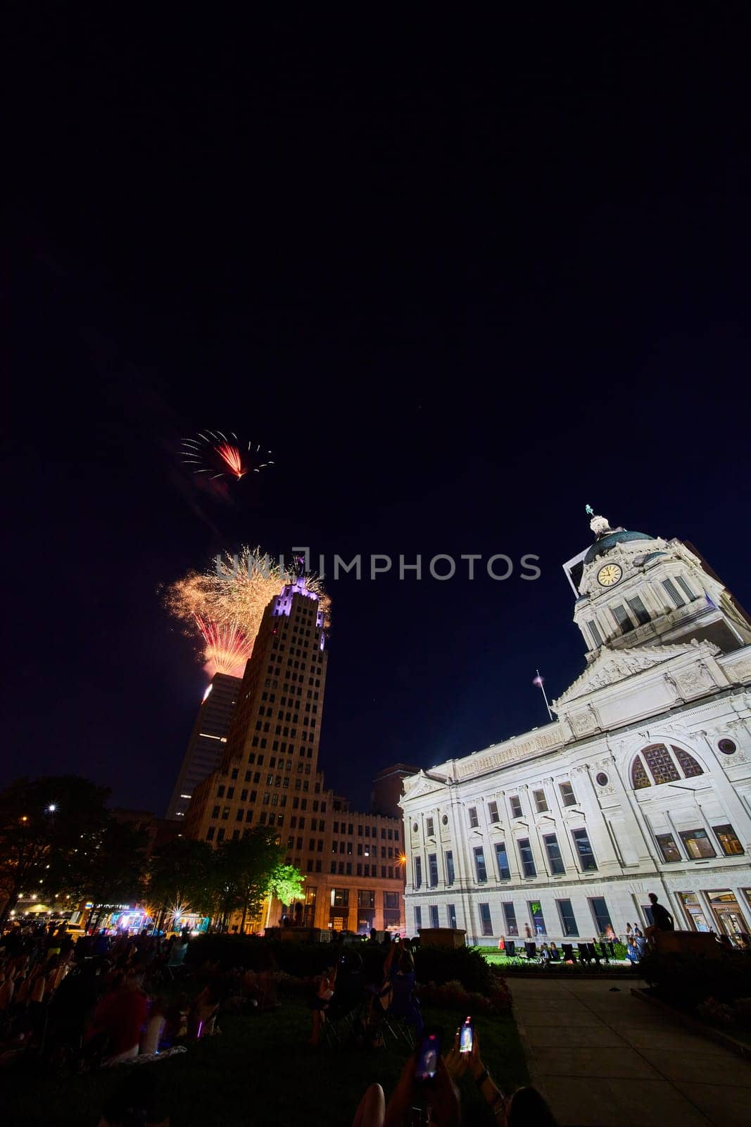 Fireworks in downtown Fort Wayne with courthouse and crowd of people watching by njproductions