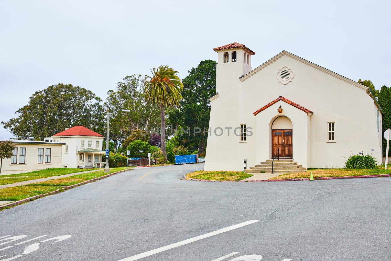 Image of Simple white church with road splitting off to either side of it