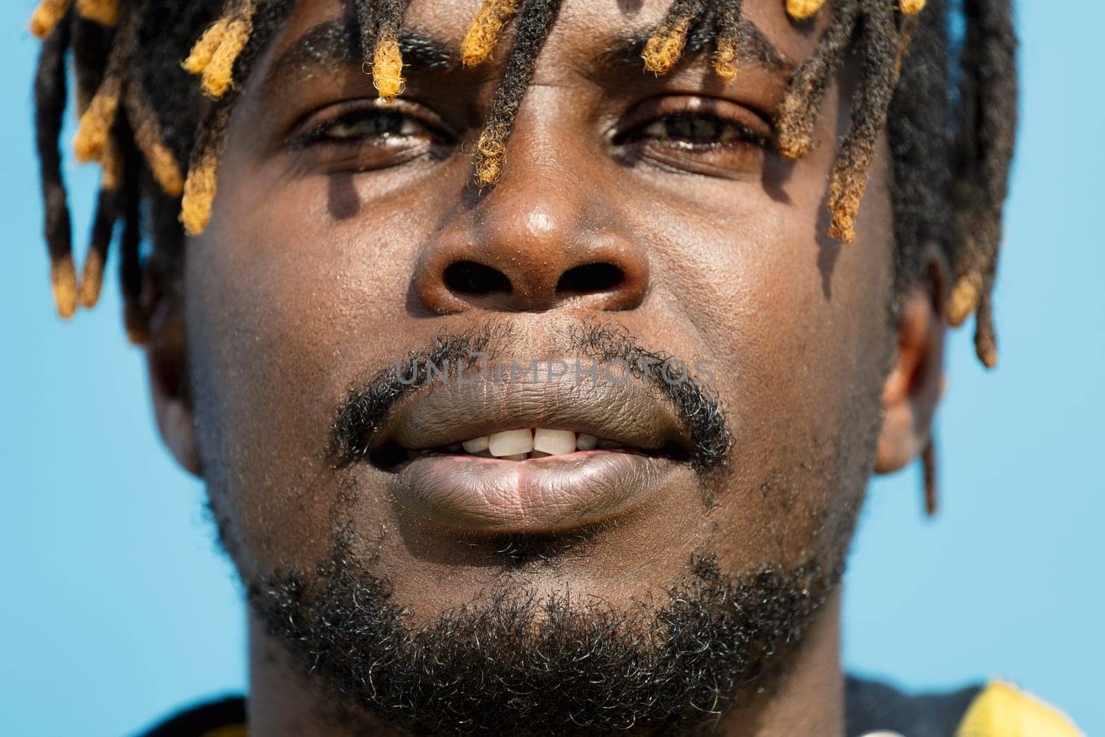 close-up of an attractive young african man, selective focus on the mouth, lifestyle concept