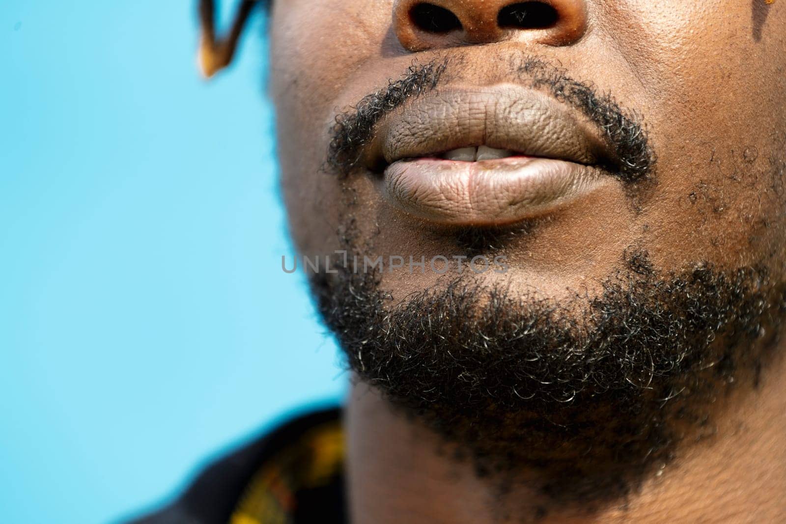 close-up of an attractive young black man's mouth, lifestyle concept