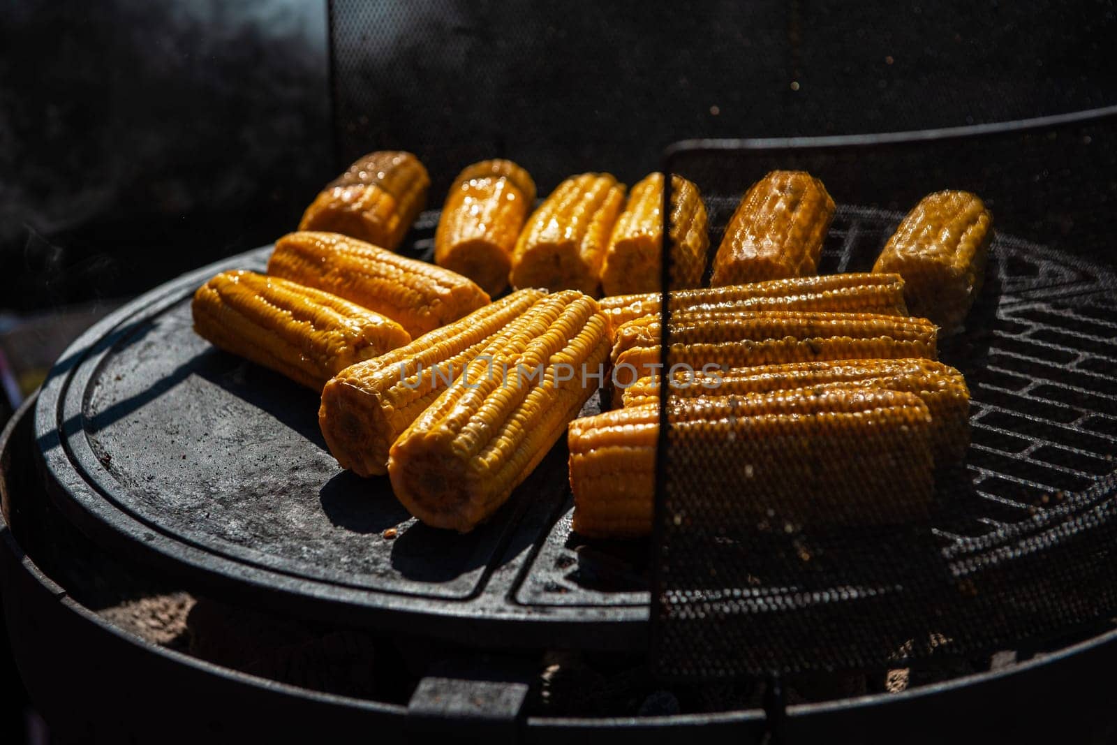 A professional cook prepares corn on the grill outdoor, food or catering concept