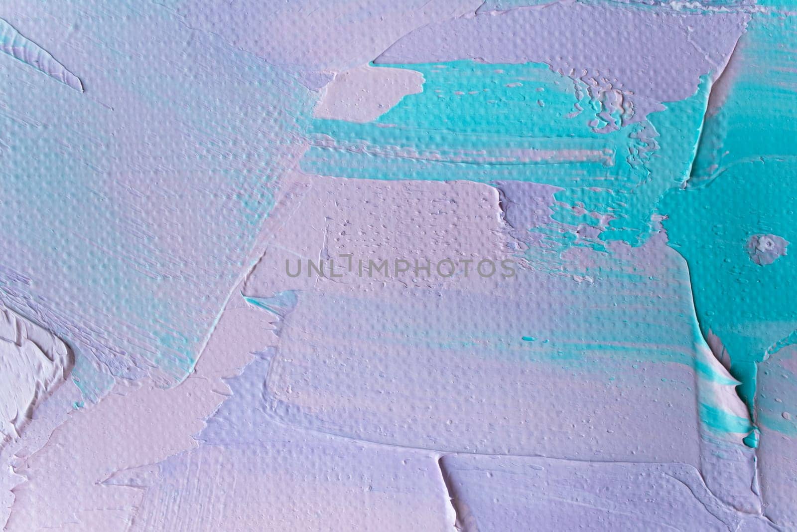 This abstract artwork displays soft pastel hues of blue and lavender, showcasing textured swaths of color applied to canvas in a creative process during a tranquil afternoon.