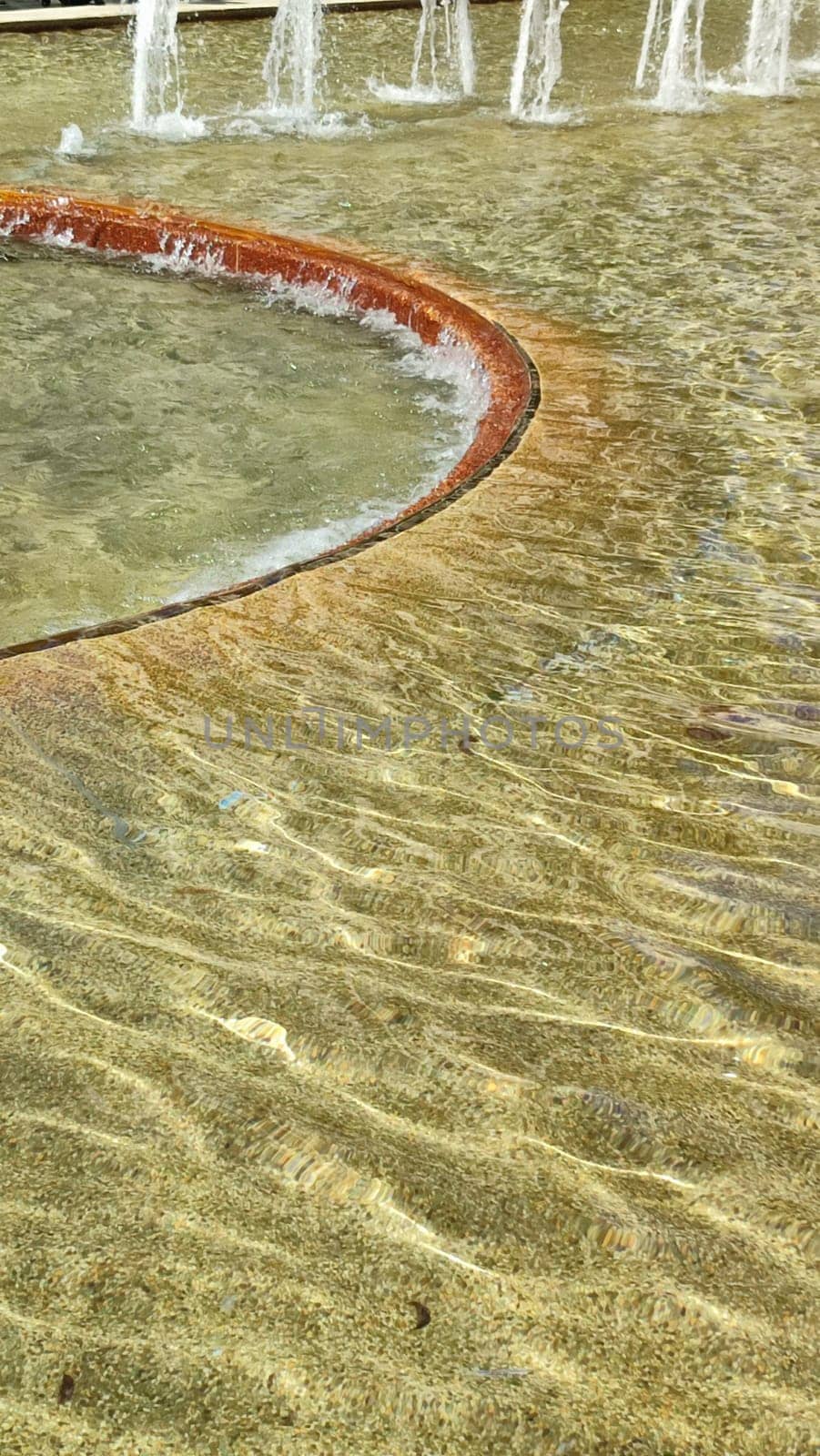 yellow color abstract background, texture water fountains, fountain pool. High quality photo