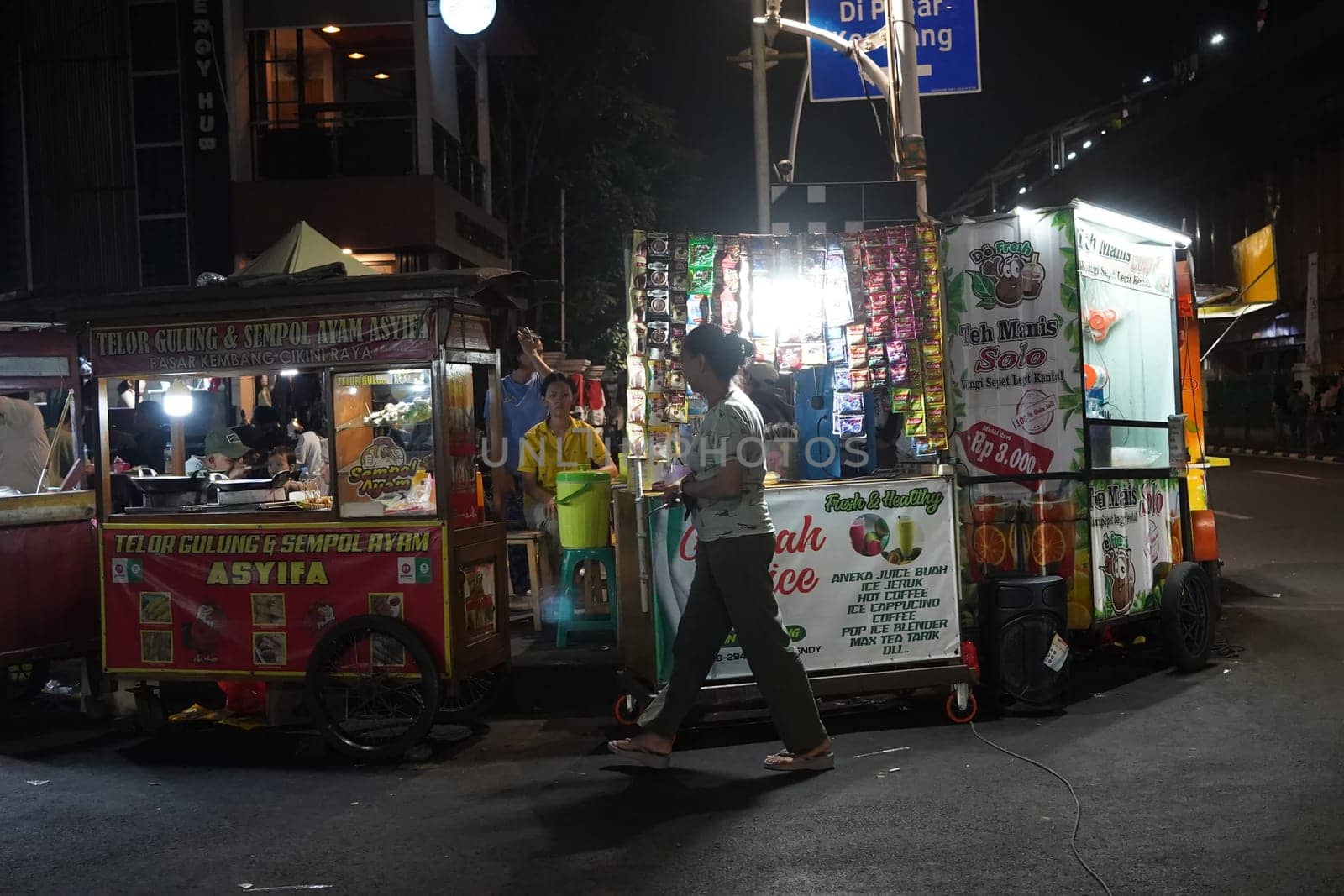 August 14, 2024. Jakarta, Indonesia. A bustling night scene in a corner of the city, filled with street vendors and shoppers.