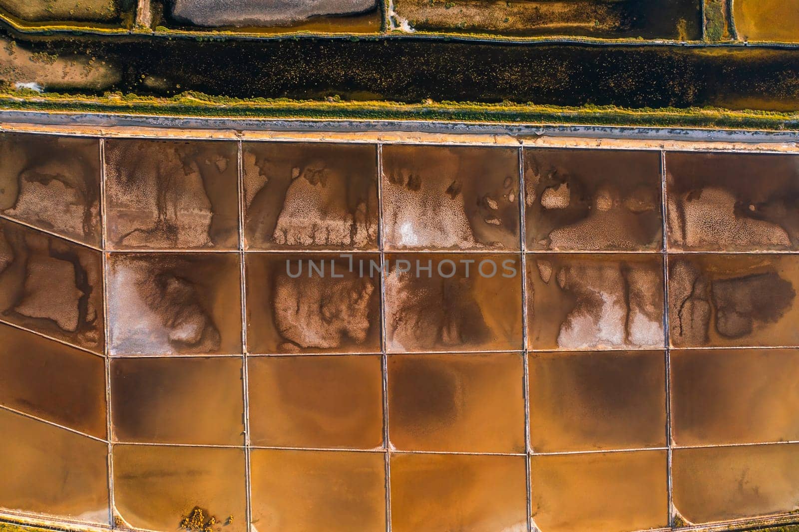 Salt pans divided into sections with seawater on Pag Island. High-quality sea salt production using traditional and safe methods in Croatia