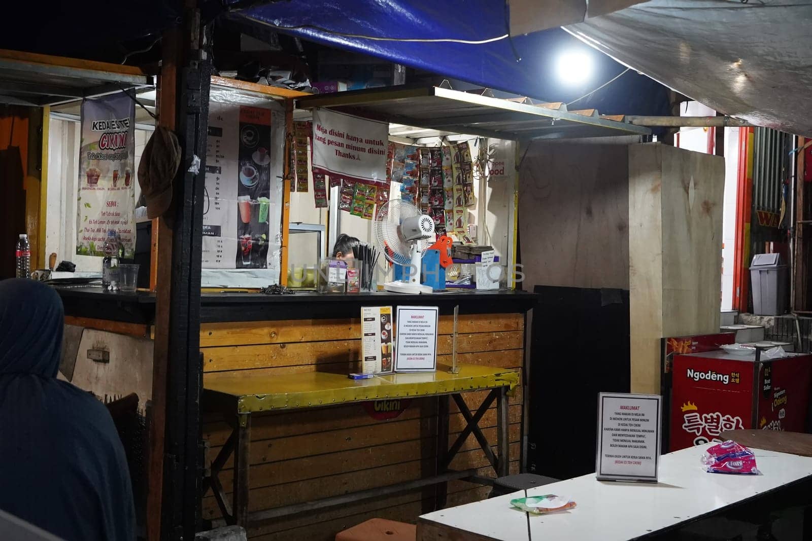 August 14, 2024. Jakarta, Indonesia. A bustling night scene in a corner of the city, filled with street vendors and shoppers.