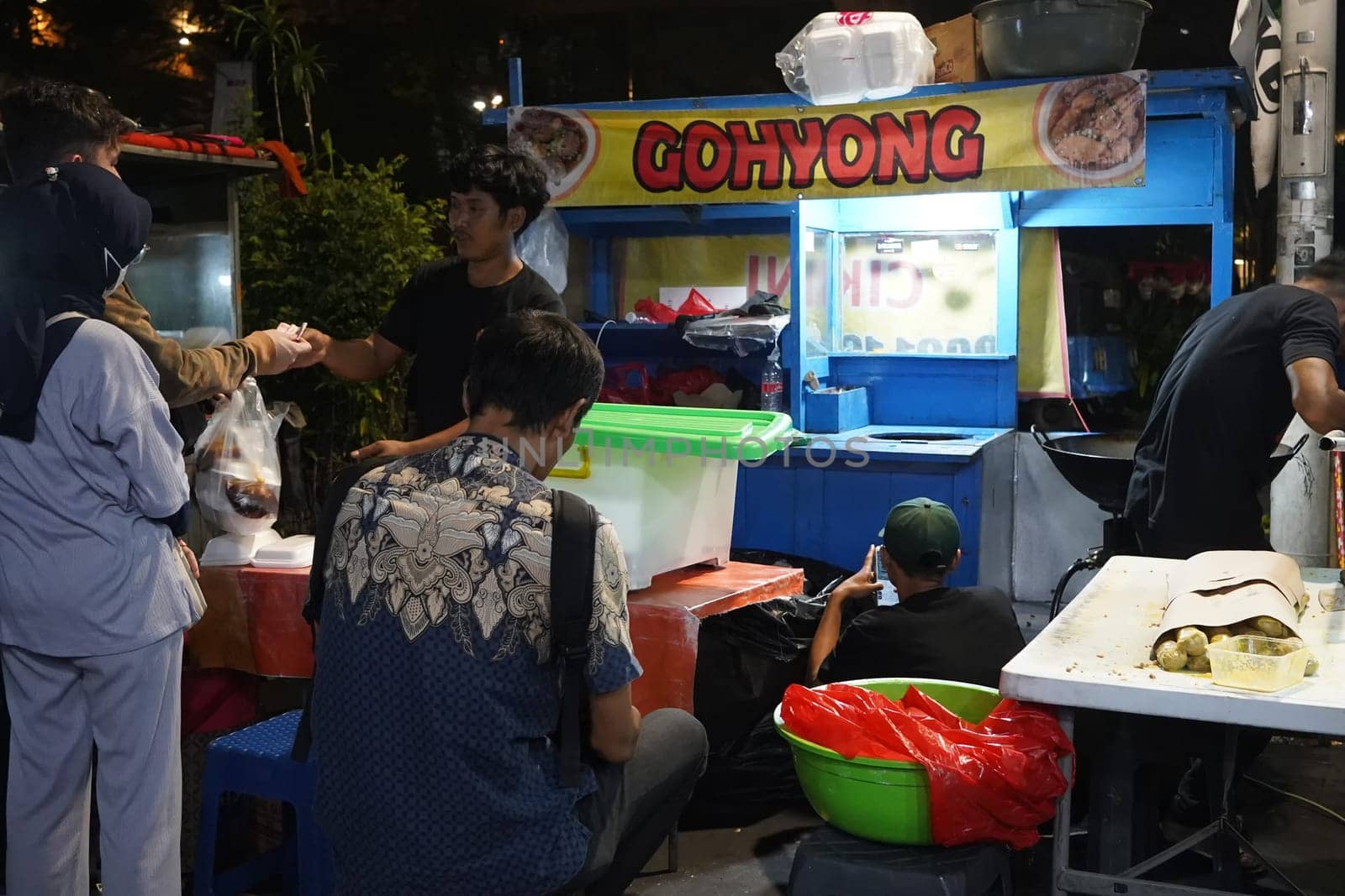 August 14, 2024. Jakarta, Indonesia. A bustling night scene in a corner of the city, filled with street vendors and shoppers.