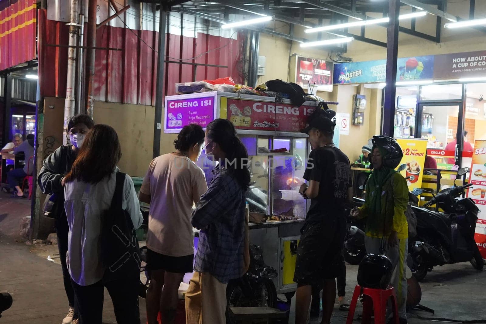 August 14, 2024. Jakarta, Indonesia. A bustling night scene in a corner of the city, filled with street vendors and shoppers.