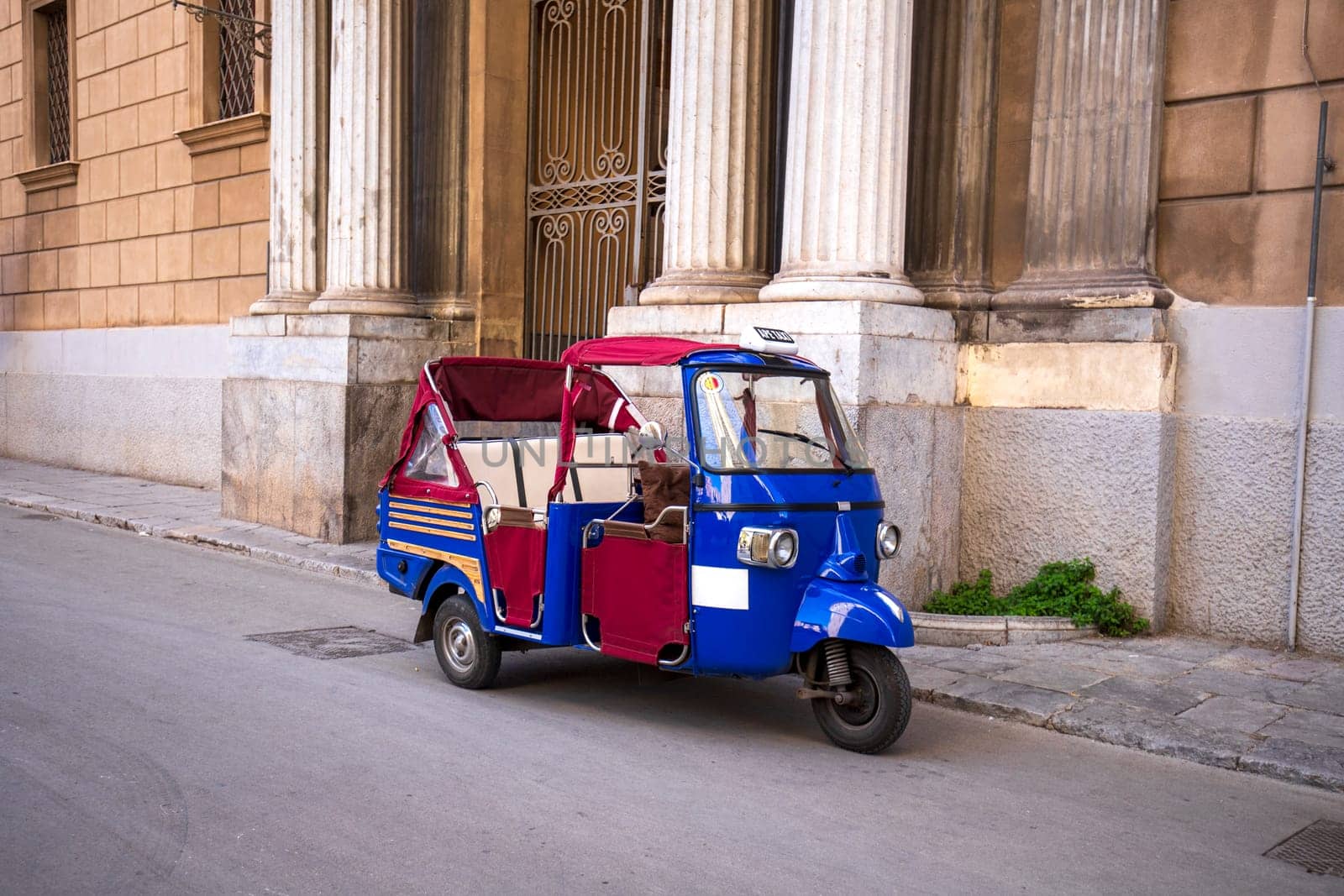 A traditional ape taxi on the streets of Palermo, Italy.