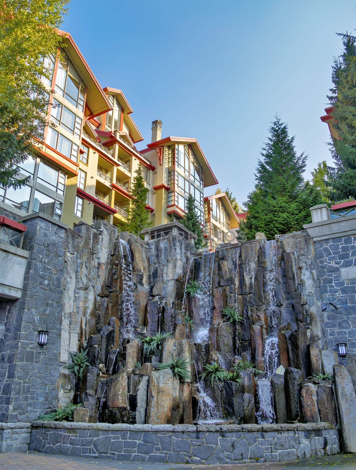 Residential block with decorative waterfall on sunset time in Whistler, British Columbia