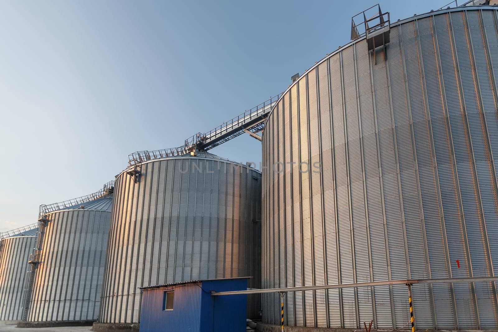 Panoramic view of industrial silos and grain storage facilities at sunset. elevator, grain storage facility