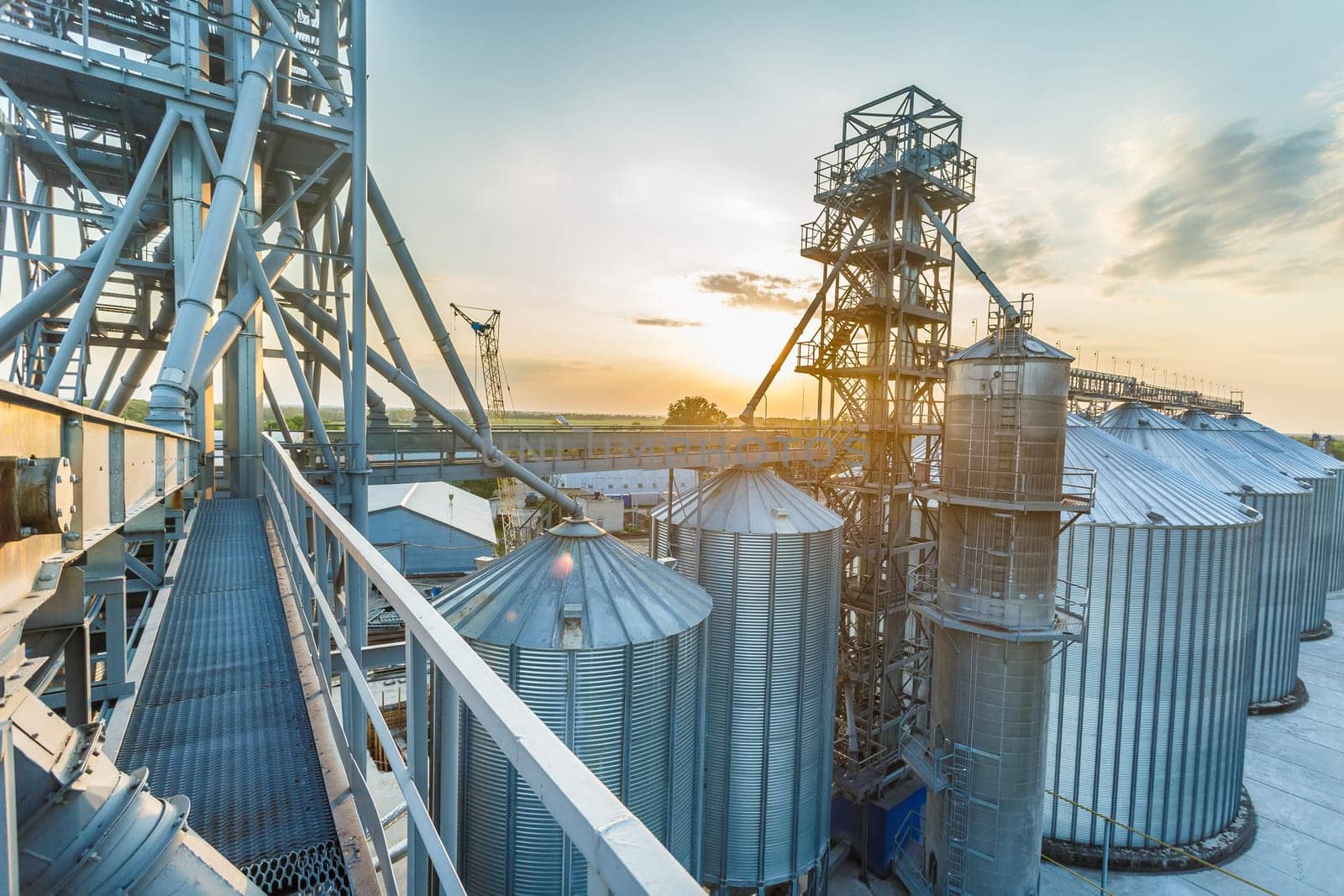 Panoramic view of industrial silos and grain storage facilities at sunset. elevator view from above, grain storage facility