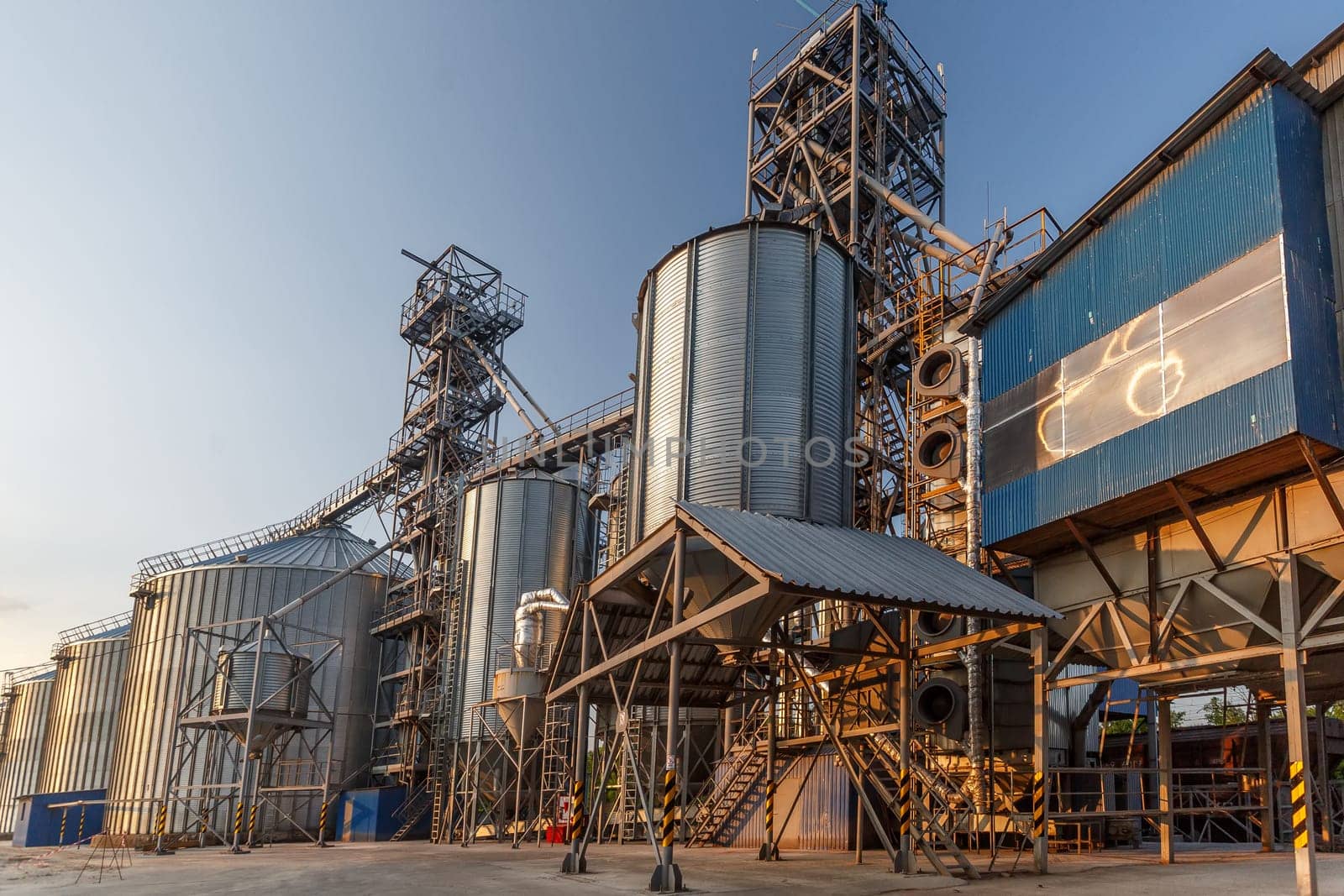 Panoramic view of industrial silos and grain storage facilities at sunset. elevator, grain storage facility